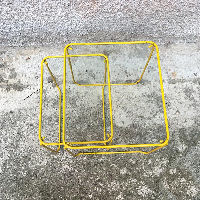 Italian yellow enameled metal and glass coffee tables, 1970s. Couple of beautiful coffee tables from the 1970s, with yellow enameled metal structure and glass top. Good general conditions.