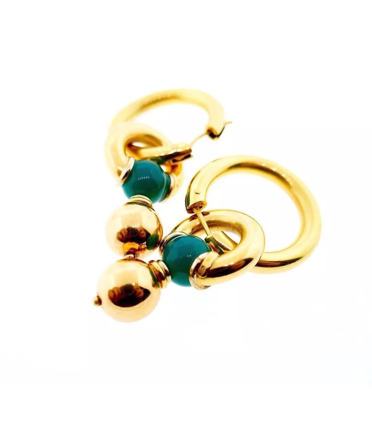 Italian 18 Karat Yellow Gold Chrysoprase Interchangeable Earrings

These are very fun and versatile earrings featuring a unique design and excellent Italian craftsmanship. The earrings can be worn as a drop earring or as plain hoops by detaching the