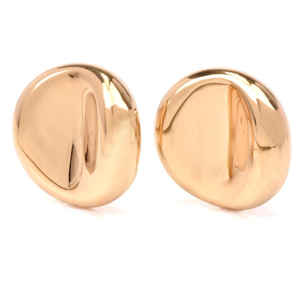These elegantly plain clip-back earrings crafted in polished 18 karat hollow yellow gold are of Italian provenance and bear the official hallmark of Italy in addition to the purity mark of '750'. The earrings expose a pair of convex rounded square