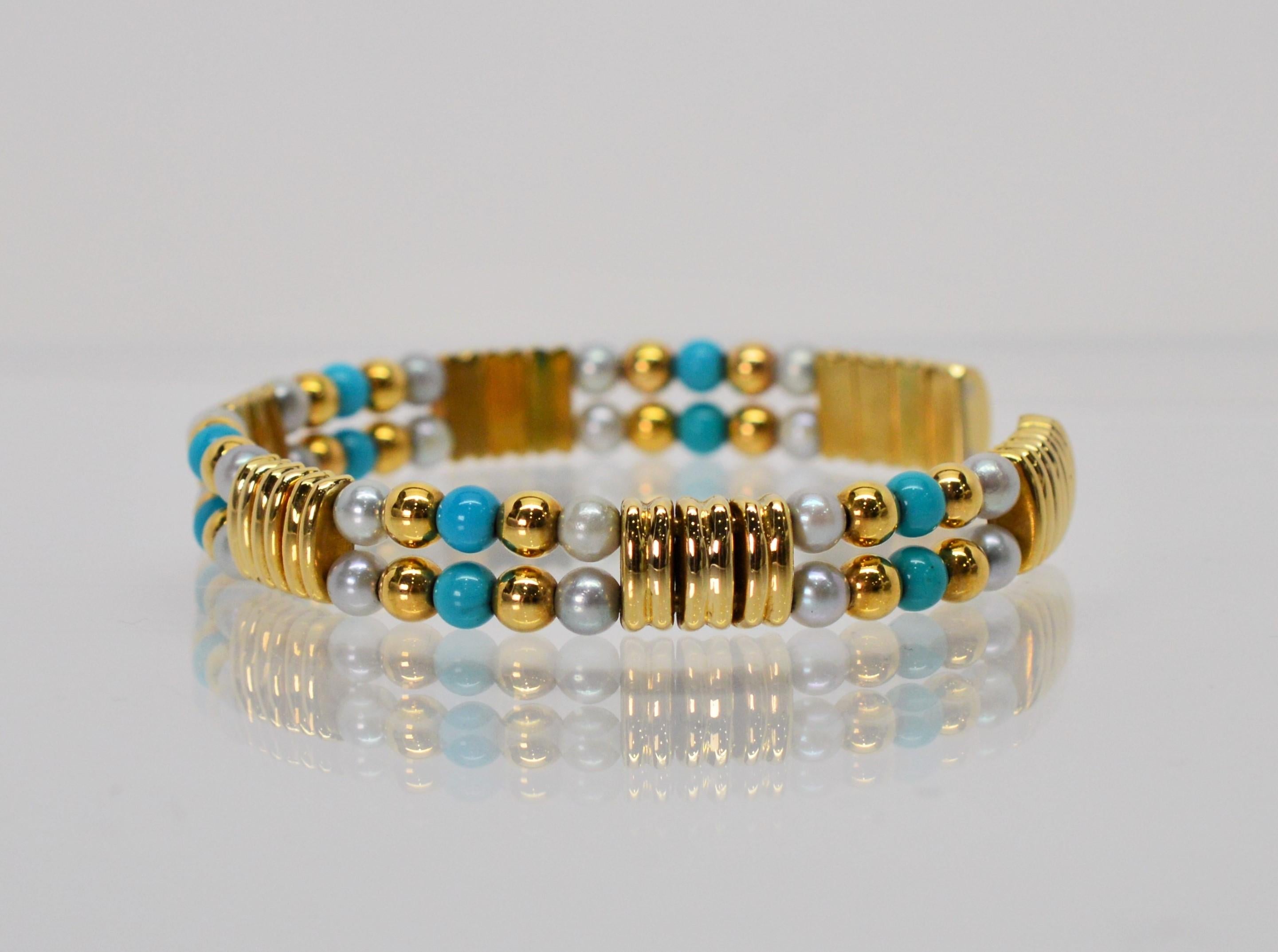 Cheerful and fresh. In eighteen karat 18K yellow gold, this quality made Italian cuff bracelet has pleasing mix shapes and colors. Rectangular gold links float across the double row cuff accented with turquoise and cultured pearl beading. Has