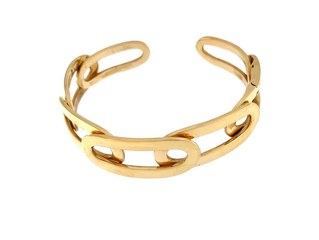 The Italian Yellow Gold Link Cuff Bracelet signed by New Ander is a testament to Italian craftsmanship and contemporary design. Crafted from luxurious 18-karat yellow gold, this bracelet exudes elegance and sophistication, making it a versatile