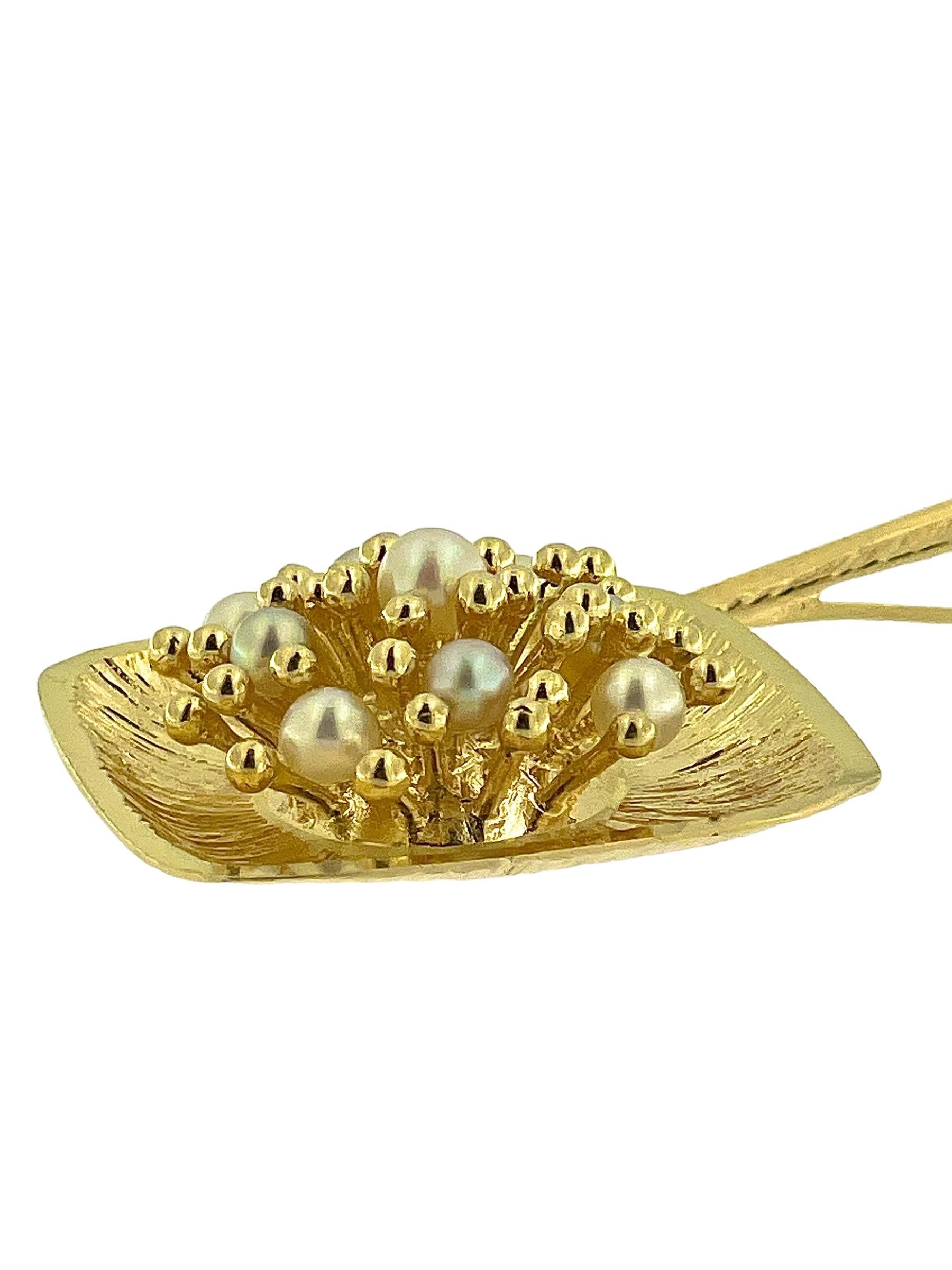 This Italian Yellow Gold Pendant is a stunning example of fine craftsmanship, crafted from 18-karat yellow gold and adorned with nine lustrous pearls. The pendant features a beautifully detailed **granulation technique**—small gold beads applied to