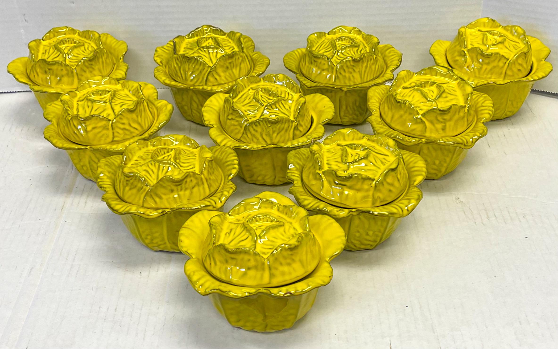 Perfect for a festive holiday table! This is a set of ten signed yellow majolica glazed terracotta cabbage form serving bowls with lids. They date to the 60s and are in very good condition.