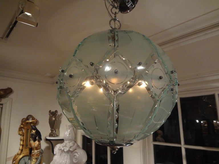Chic Italian Mid-Century Modern sandblasted glass lantern style sphere chandelier or pendant with chrome structure. This Italian lantern style glass fixture was made by 04 (Zero Quattro) edited by Fontana Arte and comes with its original chain which
