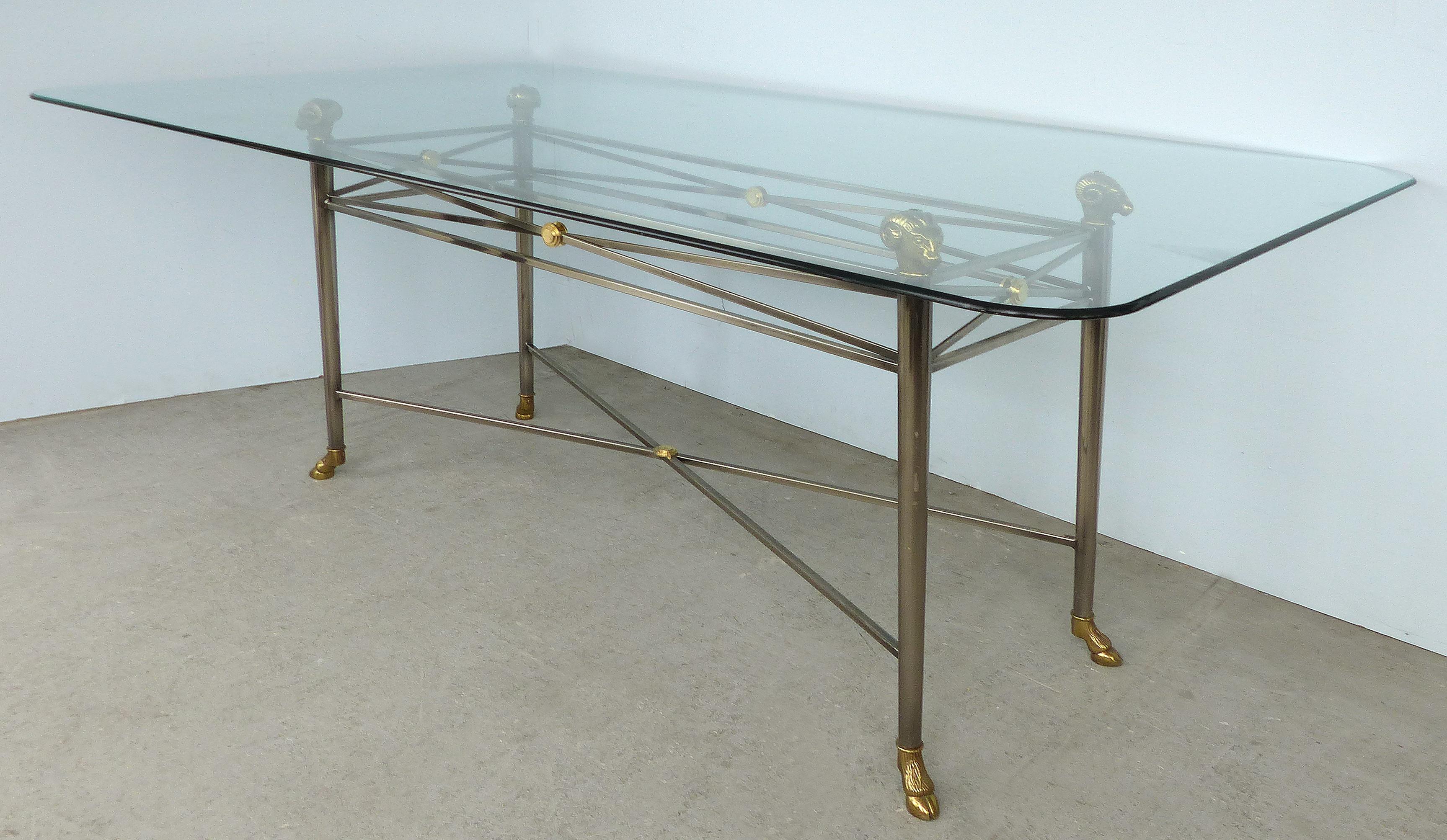 Italianate DIA Steel and Brass Dining Table with Ram's Heads and Hoof Feet

Offered for sale in an Italianate style steel and brass dining table with ram's head and hoof feet and glass top manufactured by the Design Institute of America (DIA). The