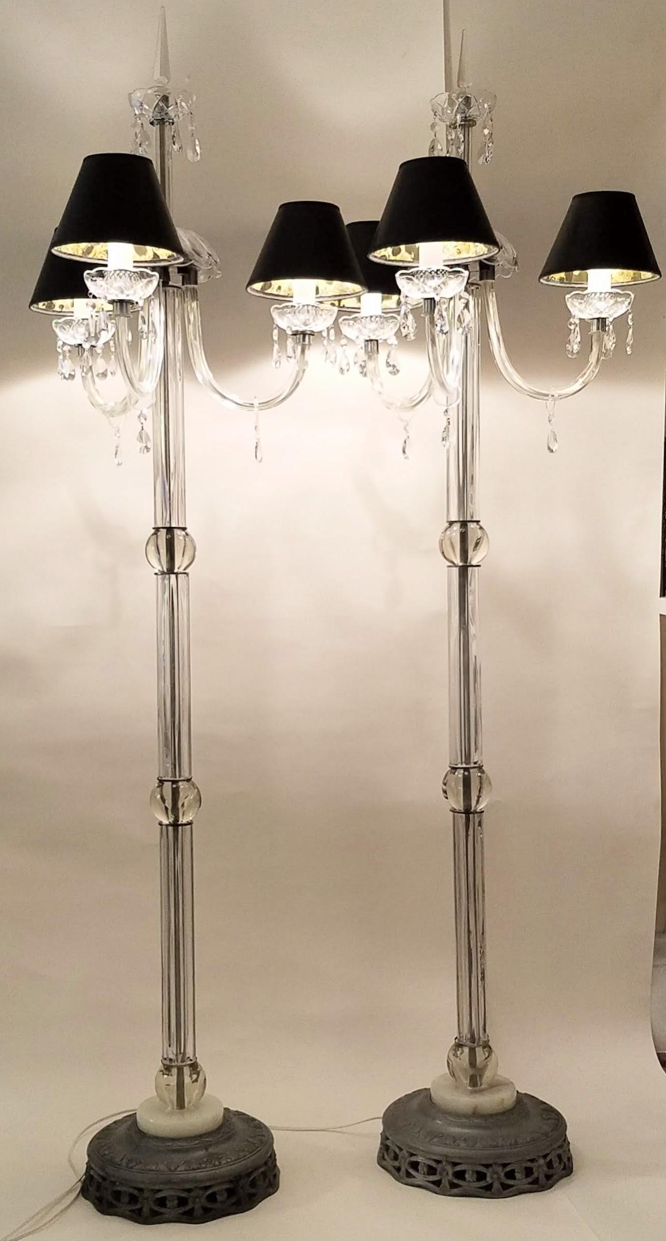 A pair of lead crystal floor lamps each with three chandelier style cast glass arms.
Each arm extends 9 inches from the fluted glass central columns and crystal ball. 
The fluted glass sections are capped with nickel plated caps and separated by