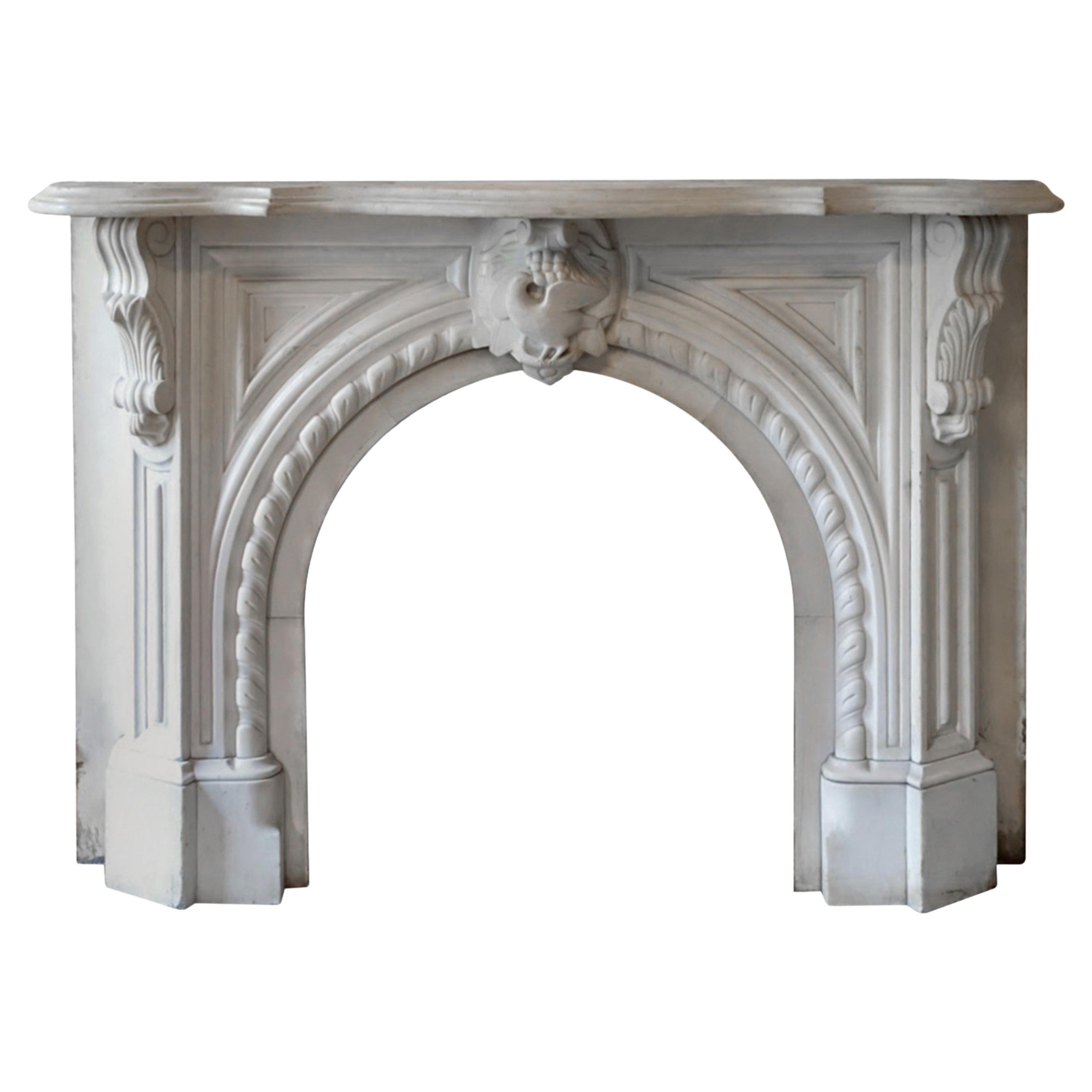 White statuary marble mantel done in an Italianate style. This mantel was originally installed in a 1920 four story Brownstone on 6th Ave in Park Slope Brooklyn, NY. The ornate hand carved details show off raised panels, angled corbels on either