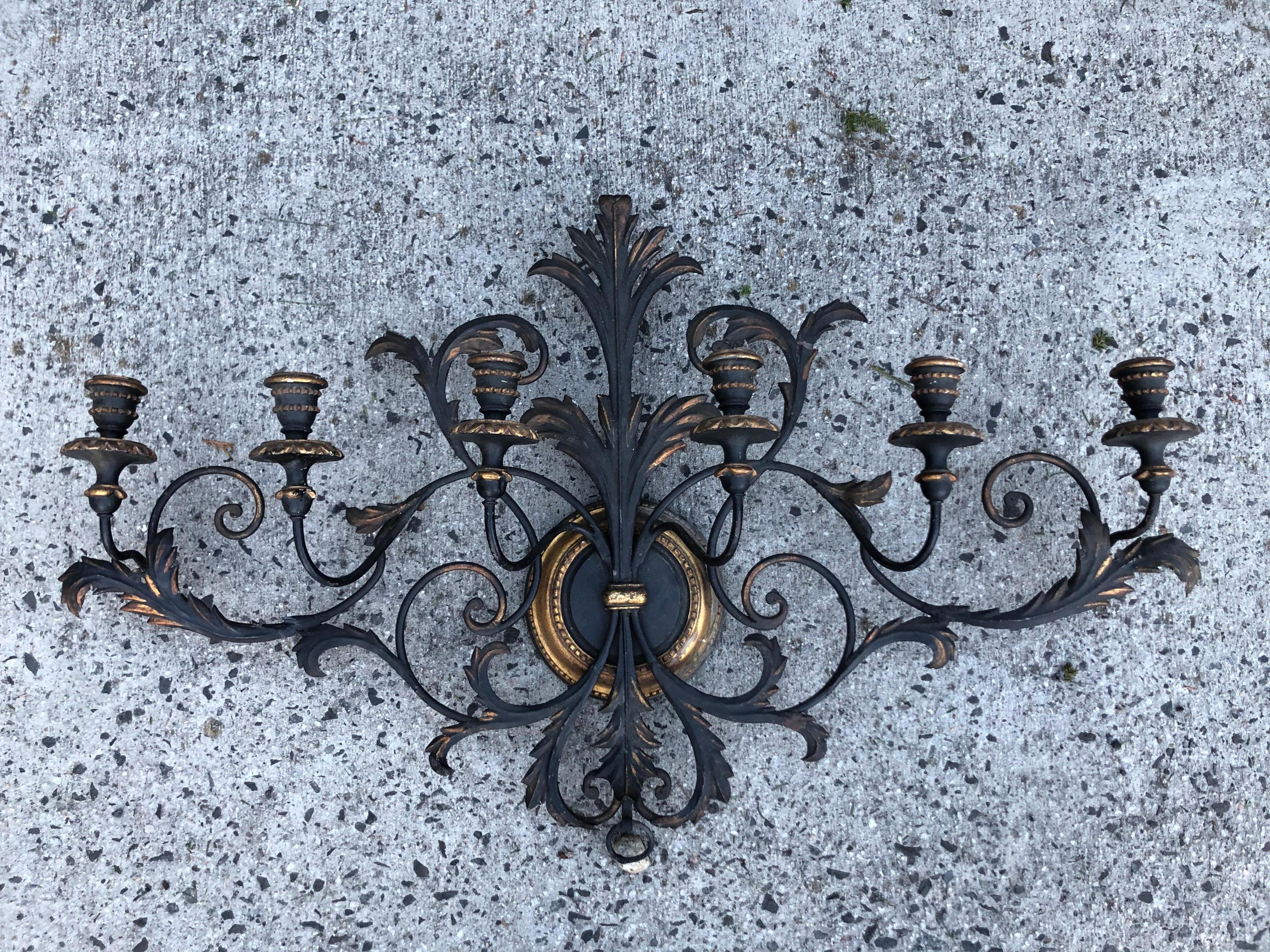 Italianate Tole and wood wall sconce. Gorgeous detailed scrolls and dramatic black and gold color. This beauty would add sophistication to any room. Holds six candles. It is not electrified but can easily be electrified. Please request a parcel