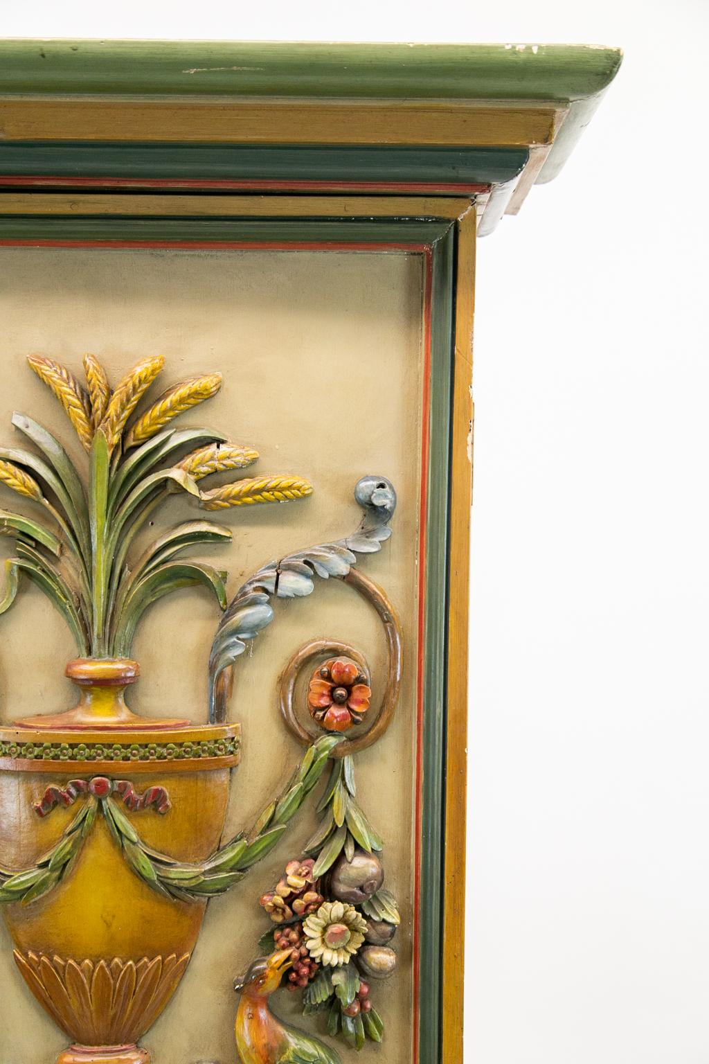 Italianesque cabinet, the door carved in very high relief with a floral urn and birds eating berries perched on floral arabesques. The inside has seven shelves.
   