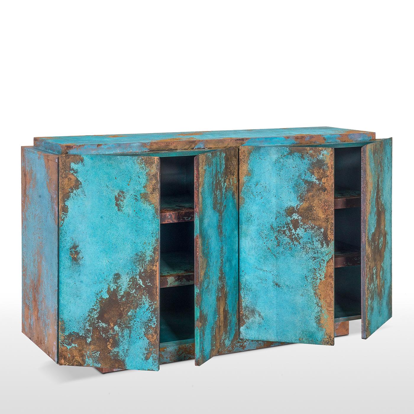 Exuding modern charm and sophistication, this sideboard boasts a linear Silhouette with plinth base and a rectangular body, all handcrafted of blockboard and MDF. The striking ocean blue and turquoise decoration is entirely applied by hand and