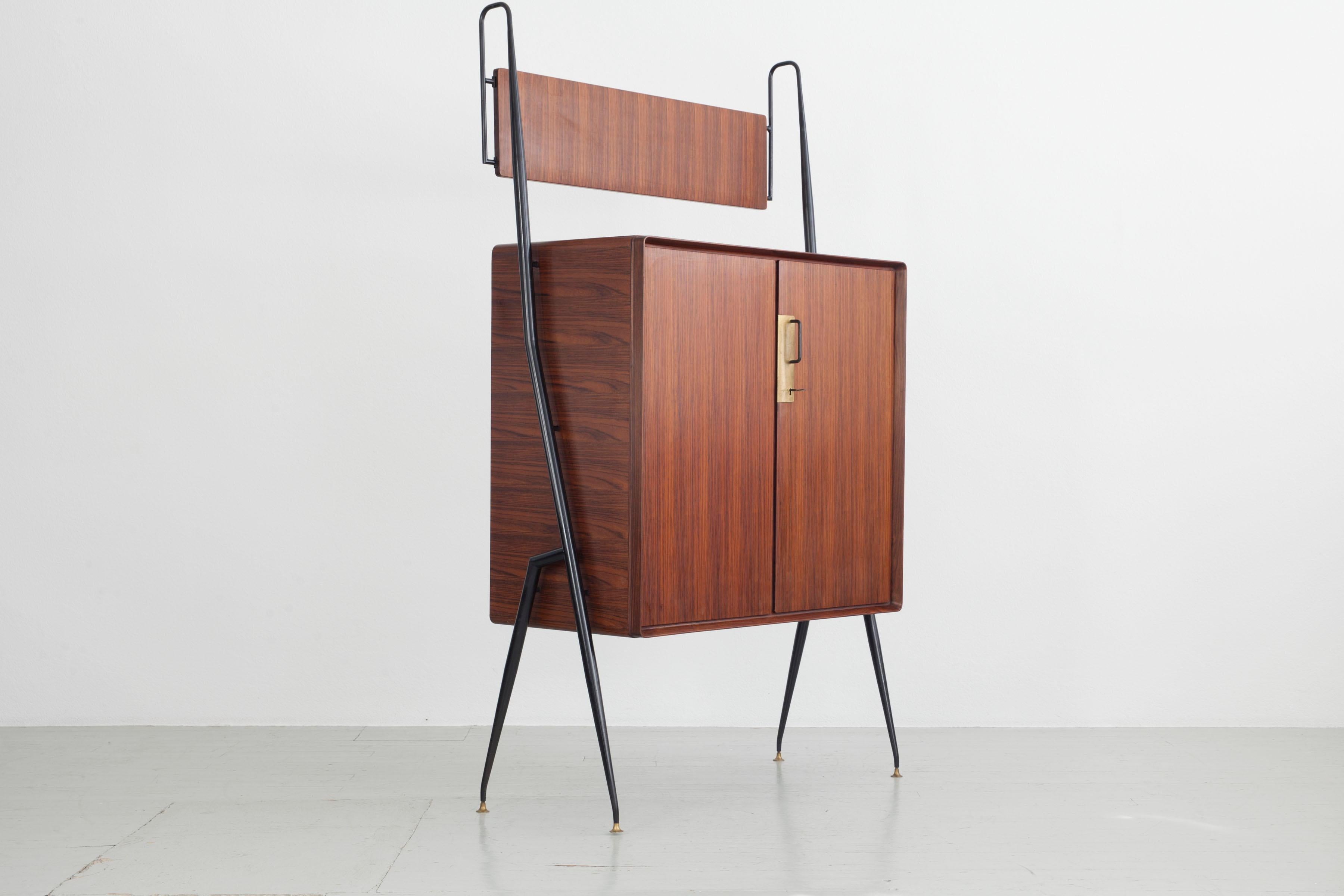 Storage cabinet made of wood, black lacquered metal legs and brass details.
Design: Silvio Cavatorta, Italy 1950s.