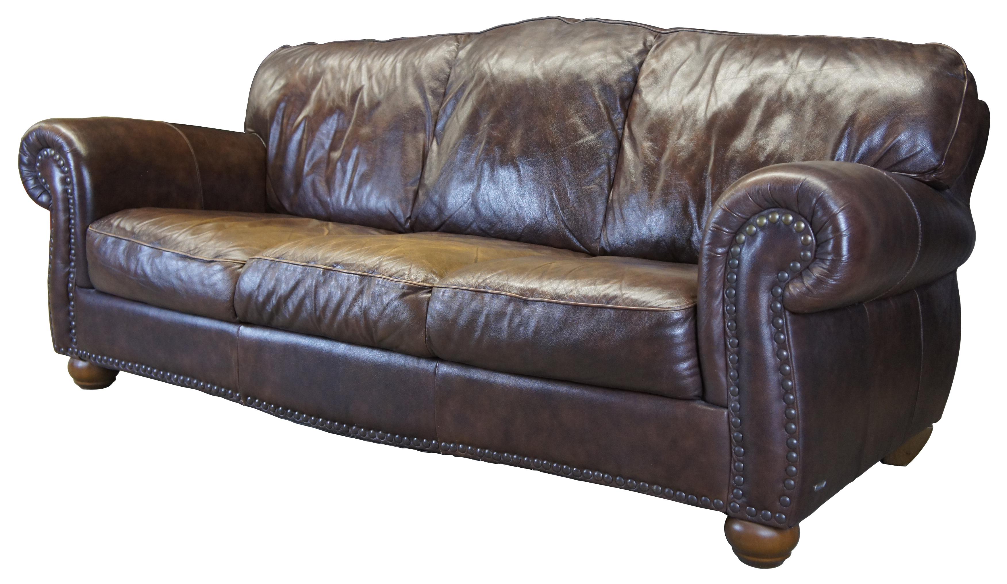 Italsofa top grain brown leather 3-seat sofa. Features a camelback and flared arms over bun feet. Accented with nailhead trim.
   