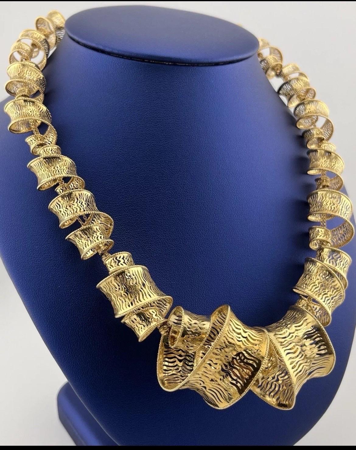 This exquisite 18k yellow gold Fratelli Bovo Spiral Mesh Necklace is a true masterpiece of Italian craftsmanship. Featuring a unique spiral mesh design, the necklace showcases an intricate weave of lustrous 18k yellow gold, creating a dynamic, fluid