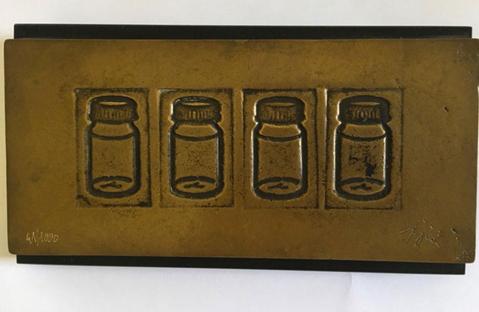 This is a multiple bronze with wood base create by the Italian artist Tino Stefanoni in 1980 circa.
This artwork is following Pop Art and its philosophy that elevates everyday objetcs to art. In this piece the artist doesn't uses the real objects
