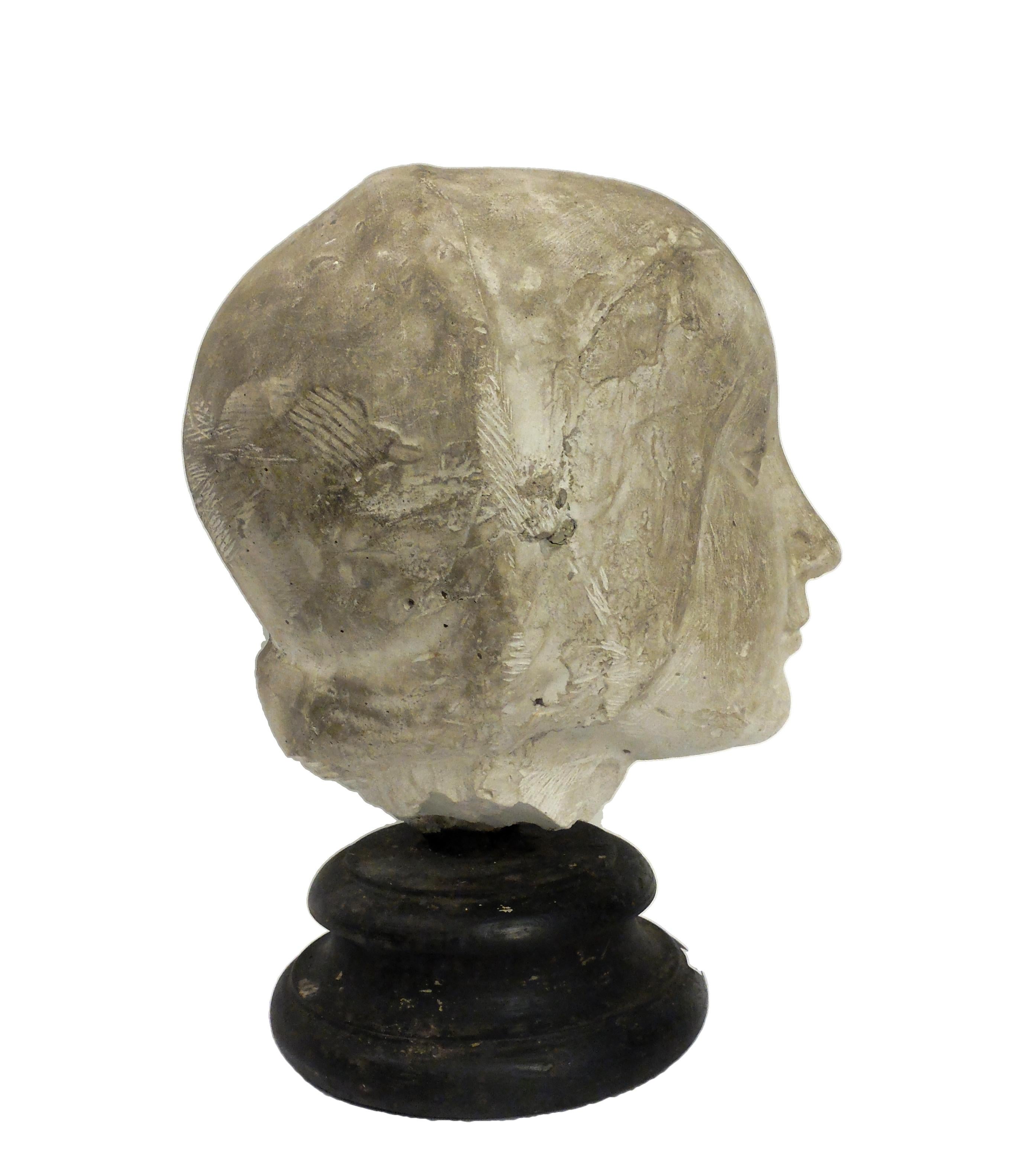 Over the wooden black painted base is set the cast of Eleonora D’Aragona head Cast for drawing teaching of student in Academy. Made out of plaster with wheel turned fruitwood ebonized base, circa 1890.