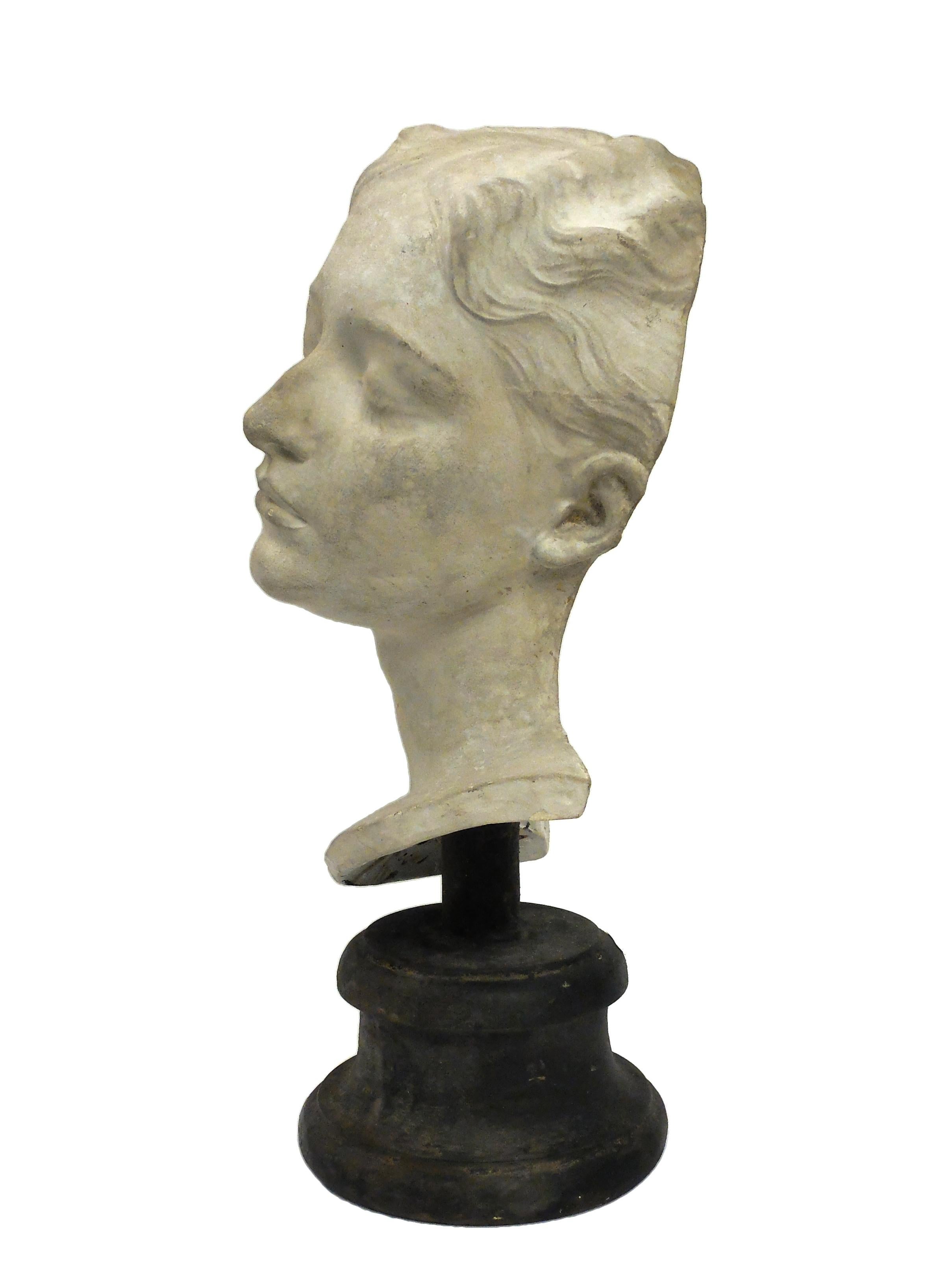 Over the wooden black painted base is set the superb cast of a young girl’s head. The cast for drawing teaching in Academy, Italy, circa 1890.