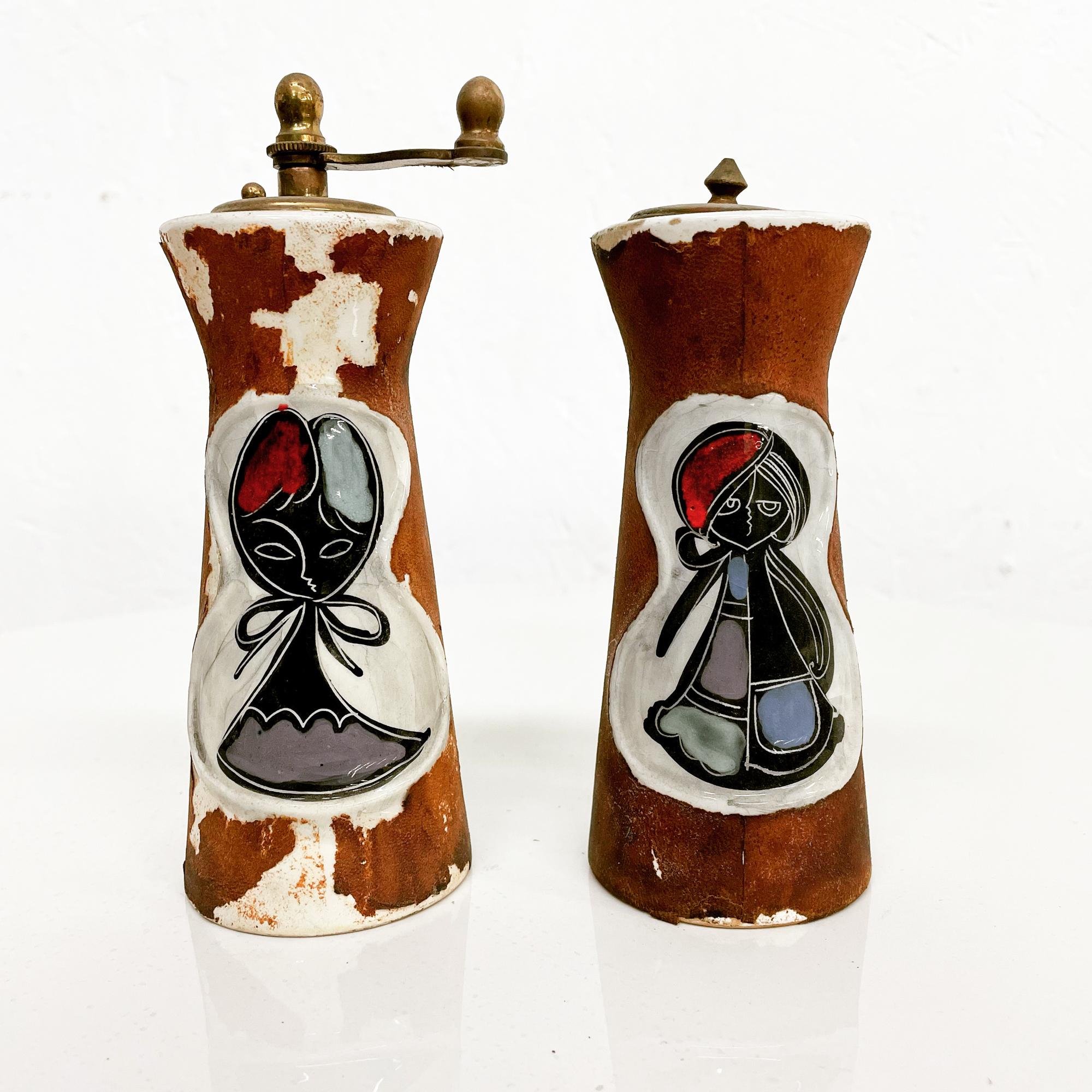 1960s Vintage Condition Italian Saltshaker Pepper Grinder Set
Decorative MCM drawing Raymor inspired design after Marcello Fantoni.
Stamped ITALY
Crafted in Ceramic and Leather. Vintage leather wrap is peeling.
Measures: 5.38 H x 2.38 in diameter