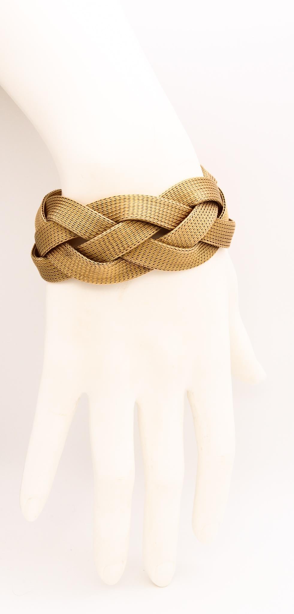 Unusual Italian mid-century braided bracelet.

Gorgeous over-sized designer's bracelet created in Italy immediately after the war, circa 1950. This beautiful and unusual piece was crafted in solid yellow gold of 18 karats. The design is composed by