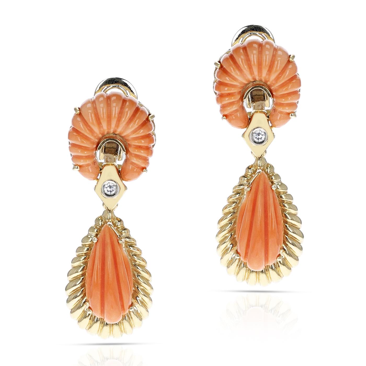 A pair of Van Cleef & Arpels Carved Coral Drop Earrings with a diamond, made in Italy. The earrings are made in 18 Karat Yellow Gold. The total weight of the earrings is 24.95 grams. The length of the earrings is 2 inches. 