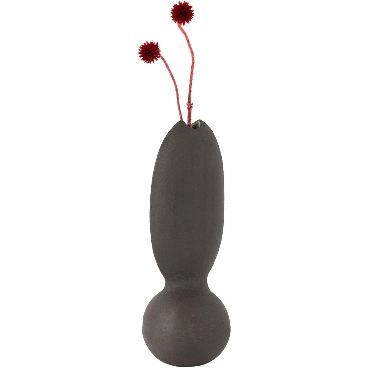 Itera Black Single Vase by Ia Kutateladze
One Of  A Kind.
Dimensions: D 10 x W 10 x H 27 cm.
Materials: Raw black clay.

Handcrafted sculptural ceramic vase in black. Please note coloration may vary. Each piece is one of a kind, due to its free