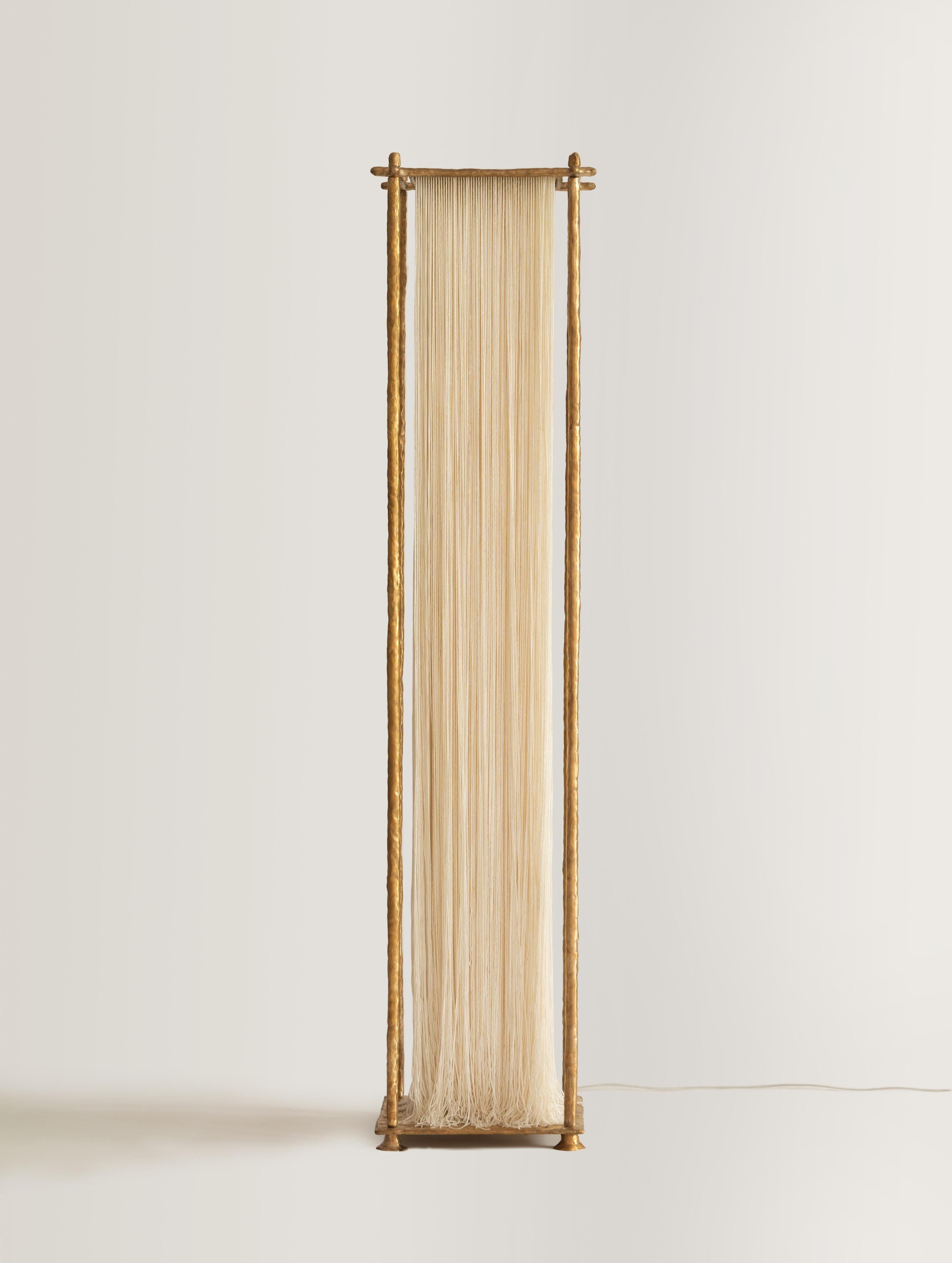 Ito Floor Lamp by Stem Design
Dimensions: D 35 x W 35 x H 182.5 cm. 
Materials: Cast brass and cotton threads.
Finish: Hand buffed. 
Weight: 33 kg.

Finished and assembled by hand in India. Please contact us. 

The Ito floor lamp embodies the