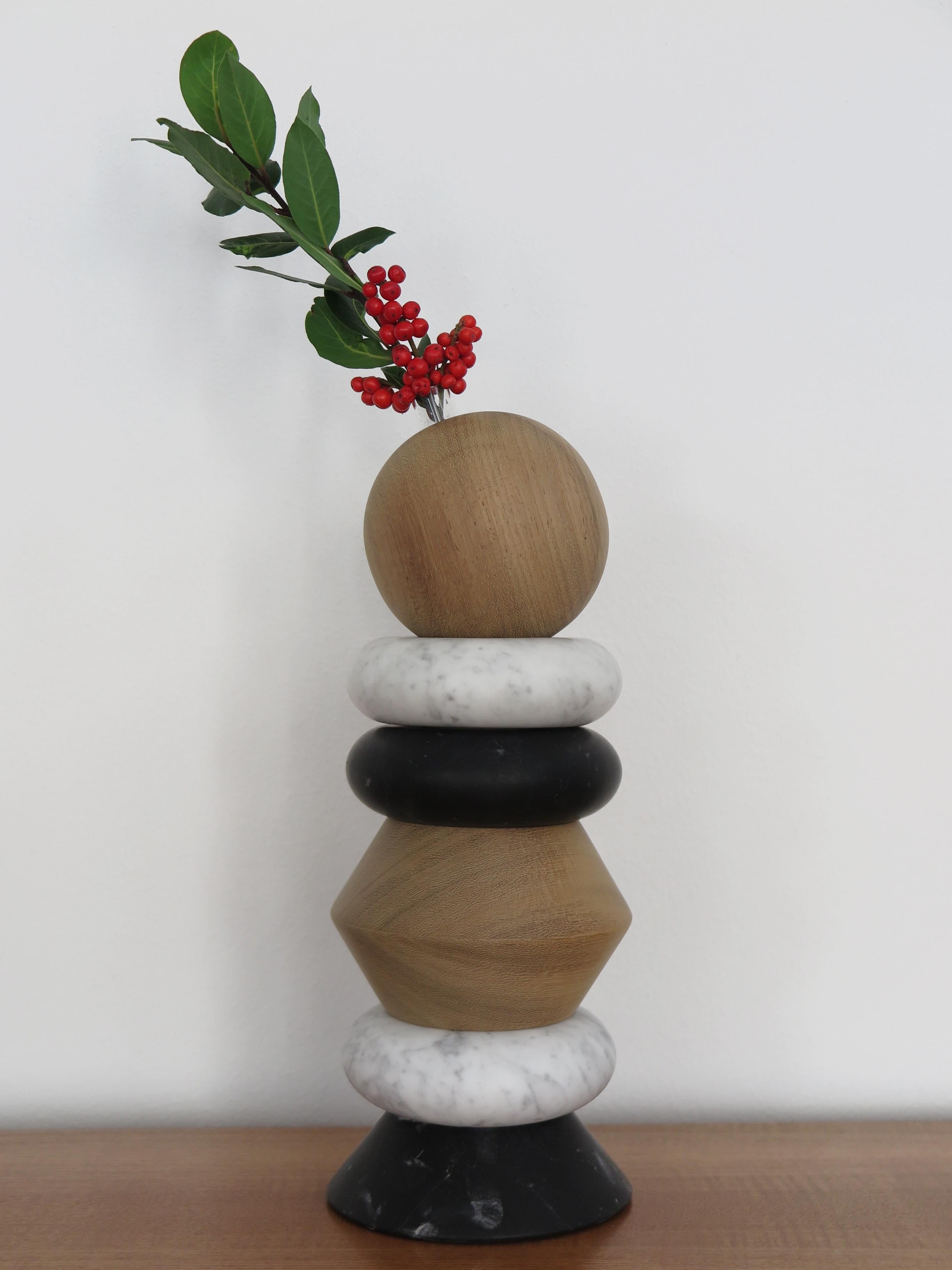 Italian contemporary sculpture, candle holder and flower vase, modular as you like made up of white marble Carrara, black marble, and solid wood with including two glass vases for fresh flowers.
The various elements can be composed and stacked as