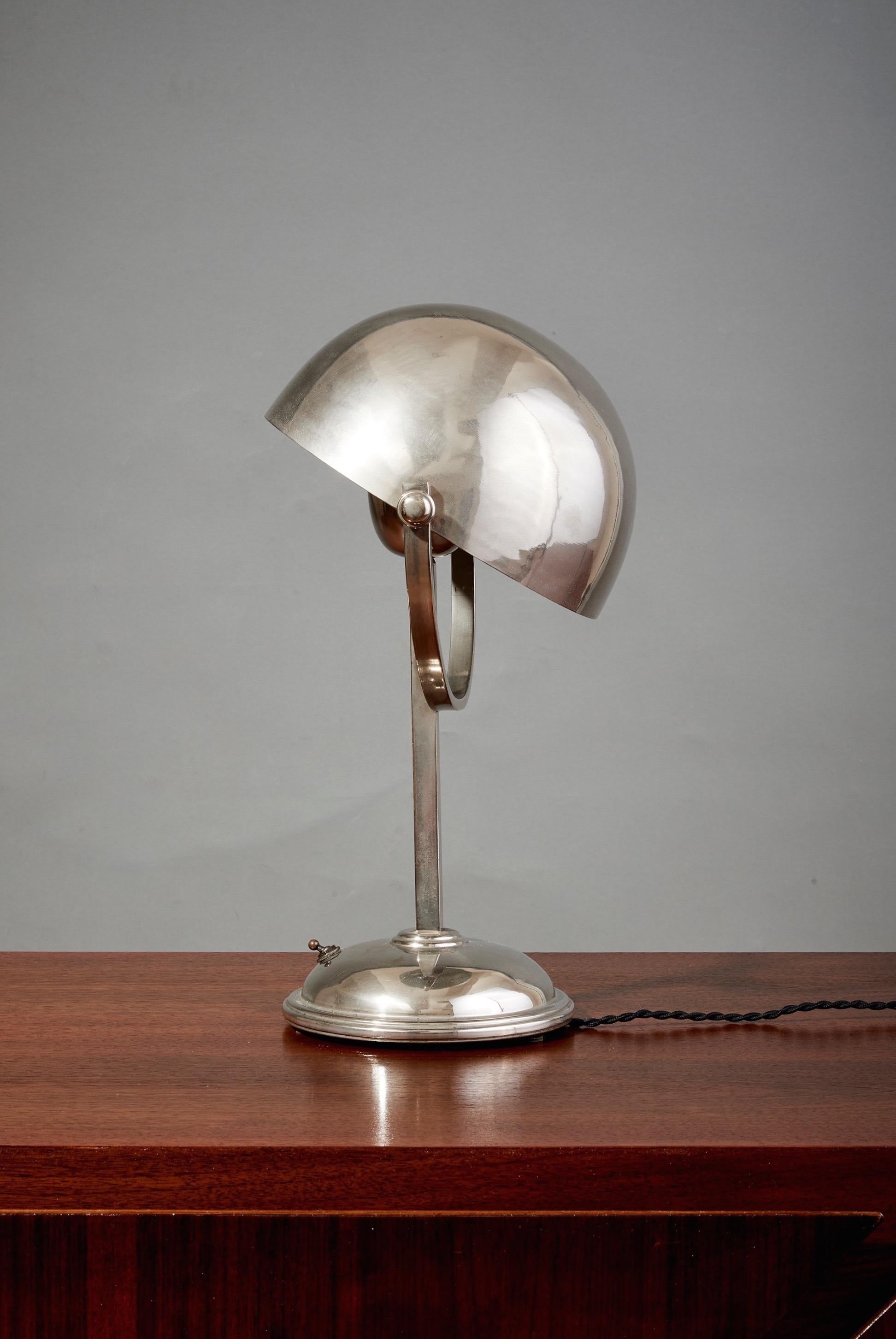 France, 1930's

A geometric Art Deco table lamp in nickel-plated brass in the style of Felix Aublet. The domed shade, fully articulated to direct light in the direction of the sitter's choosing, angles over a half-moon arch to trace a full sphere.