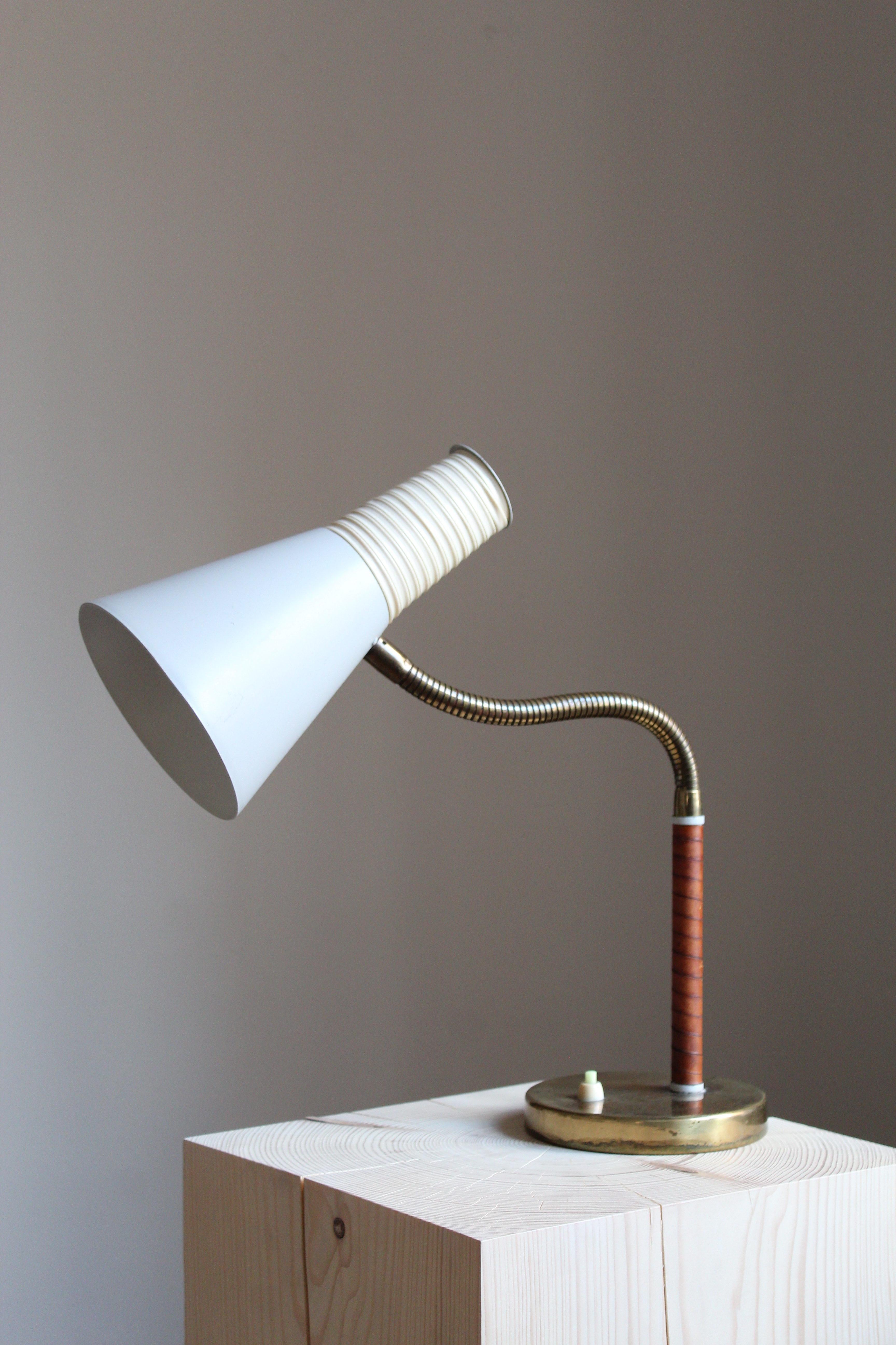 An adjustable desk / table lamp by Finnish producer Itsu. Marked. Brass, lacquered metal. Rod wrapped in original leather. Features wrapped acrylic on lampshade.

Dimensions variable, measured as illustrated in third upright position.

Other