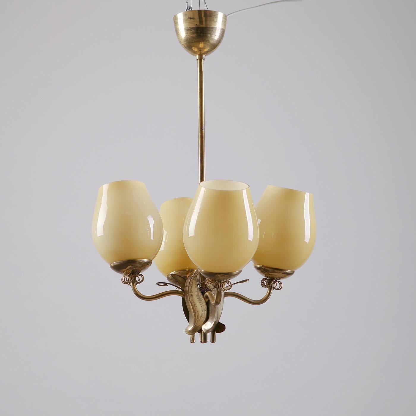 Rare ceiling lamp, produced by Itsu Oy in Finland, 1950s. Made from brass, decorative details in brass, with 4 shades in yellow-tonen opaline glass.

This elegant ceiling lamp was produced by the famed Finnish manufacturer Itsu Oy (which stands for