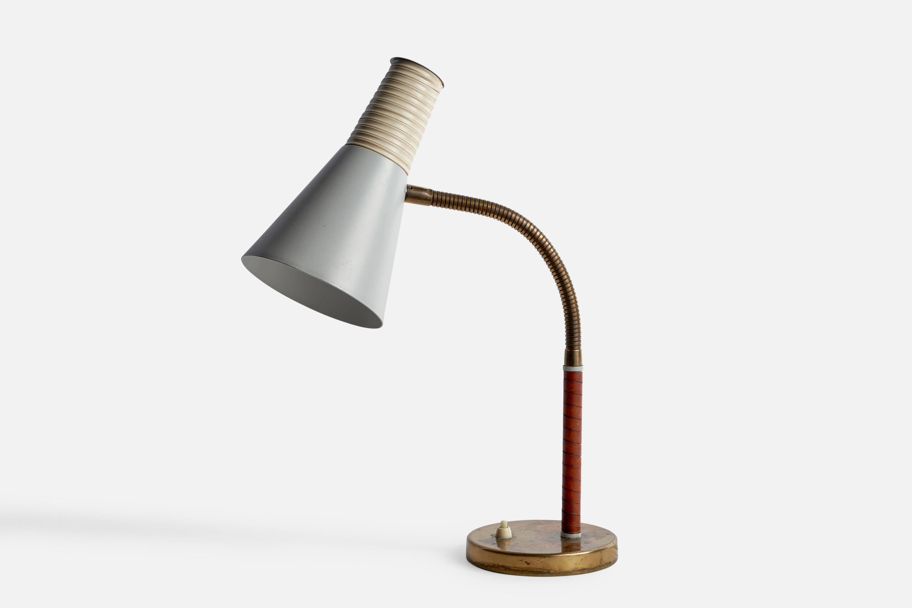 An adjustable brass, leather, white-lacquered metal and plastic band table lamp designed and produced by Itsu, Finland, 1950s.

Overall Dimensions (inches): 20.5” H x 5.5” W x 9.45” D
Bulb Specifications: E-26 Bulb
Number of Sockets: 1
All lighting