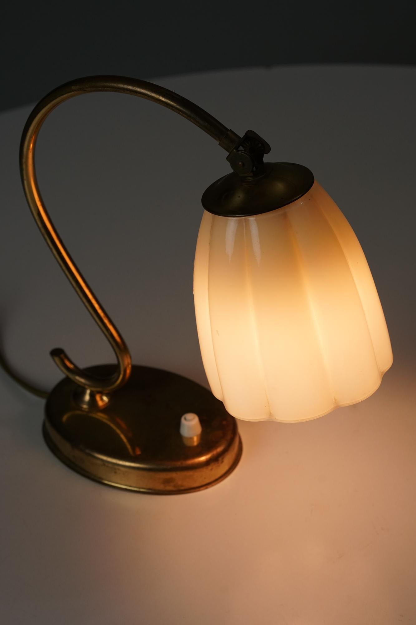 Table-/wall light manufactured by Itsu from the 1950s.Brass with opaline glass shade. Manufacturer's stamp on the bottom. Good vintage condition, minor patina and wear consistent with age and use. Beautiful Scandinavian Modern design.