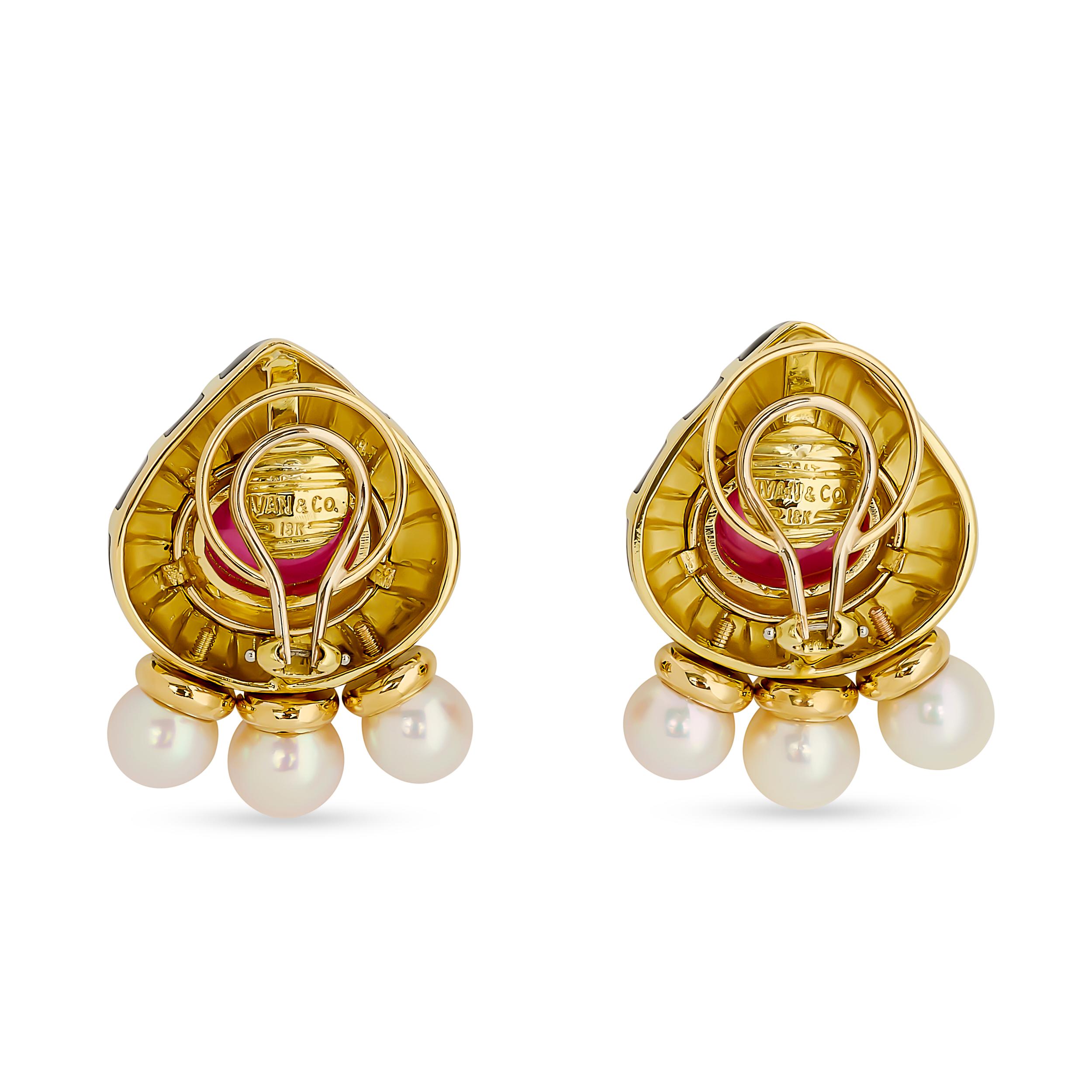 These Ivan & Co earrings showcase a striking design with teardrop-shaped black enamel inlays, each centered with a vibrant pink tourmaline cabochon and accented by delicate pearl dangles, all set in polished yellow gold.

2 cabochon tourmalines