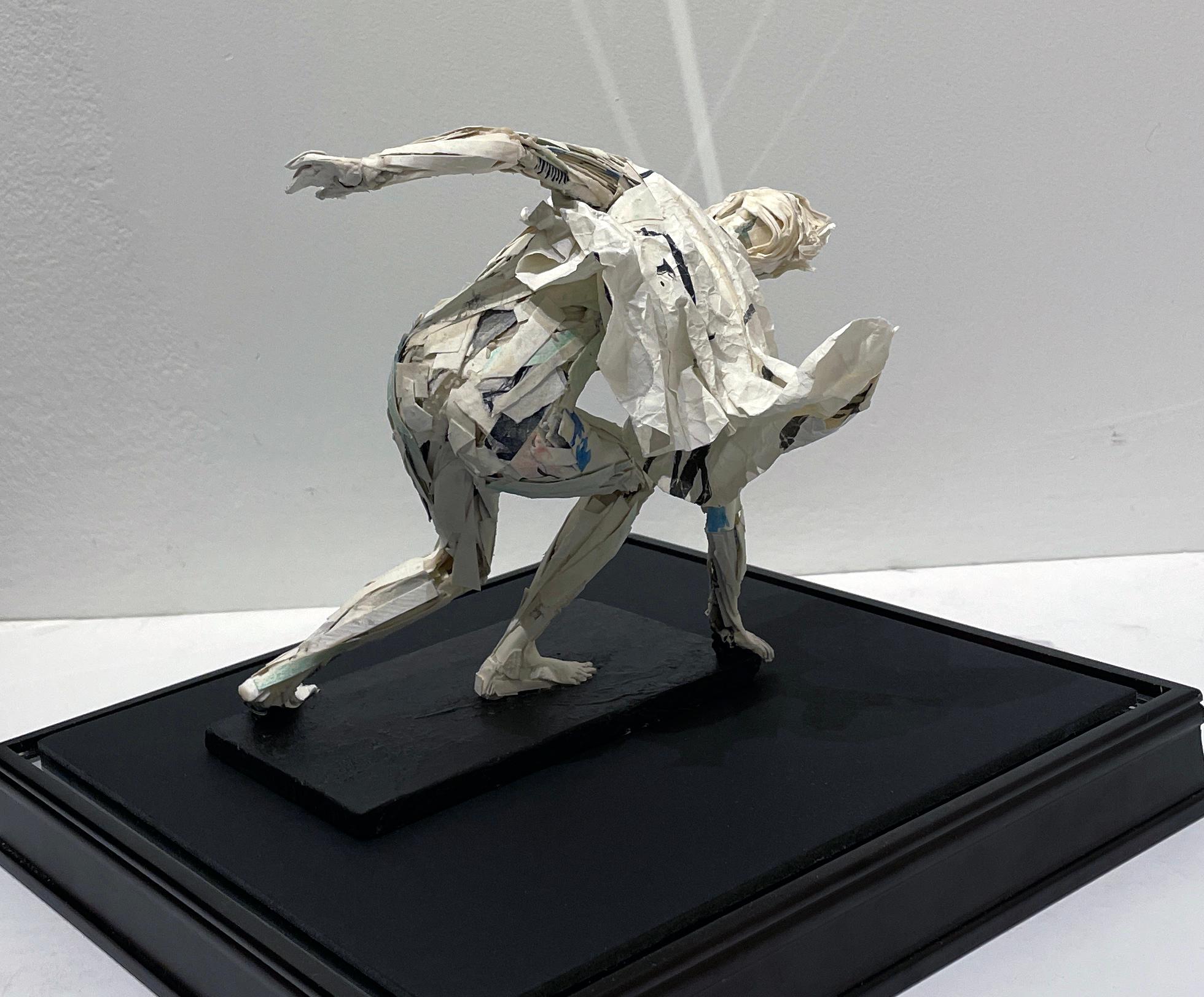 The male figure, catching himself before tumbling to the ground in Ivan Markovic's paper sculpture, 