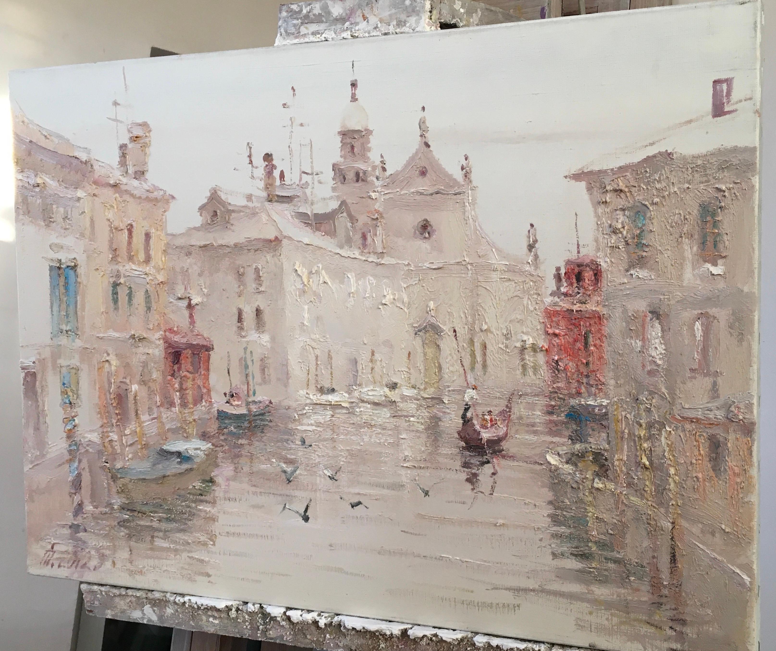 This is a soft, atmospheric painting, executed in pastel, muted tones that create the feeling of a light mist over the city. The canvas depicts a Venetian canal surrounded by ancient buildings in warm cream, pink, and ochre tones. The texture of the