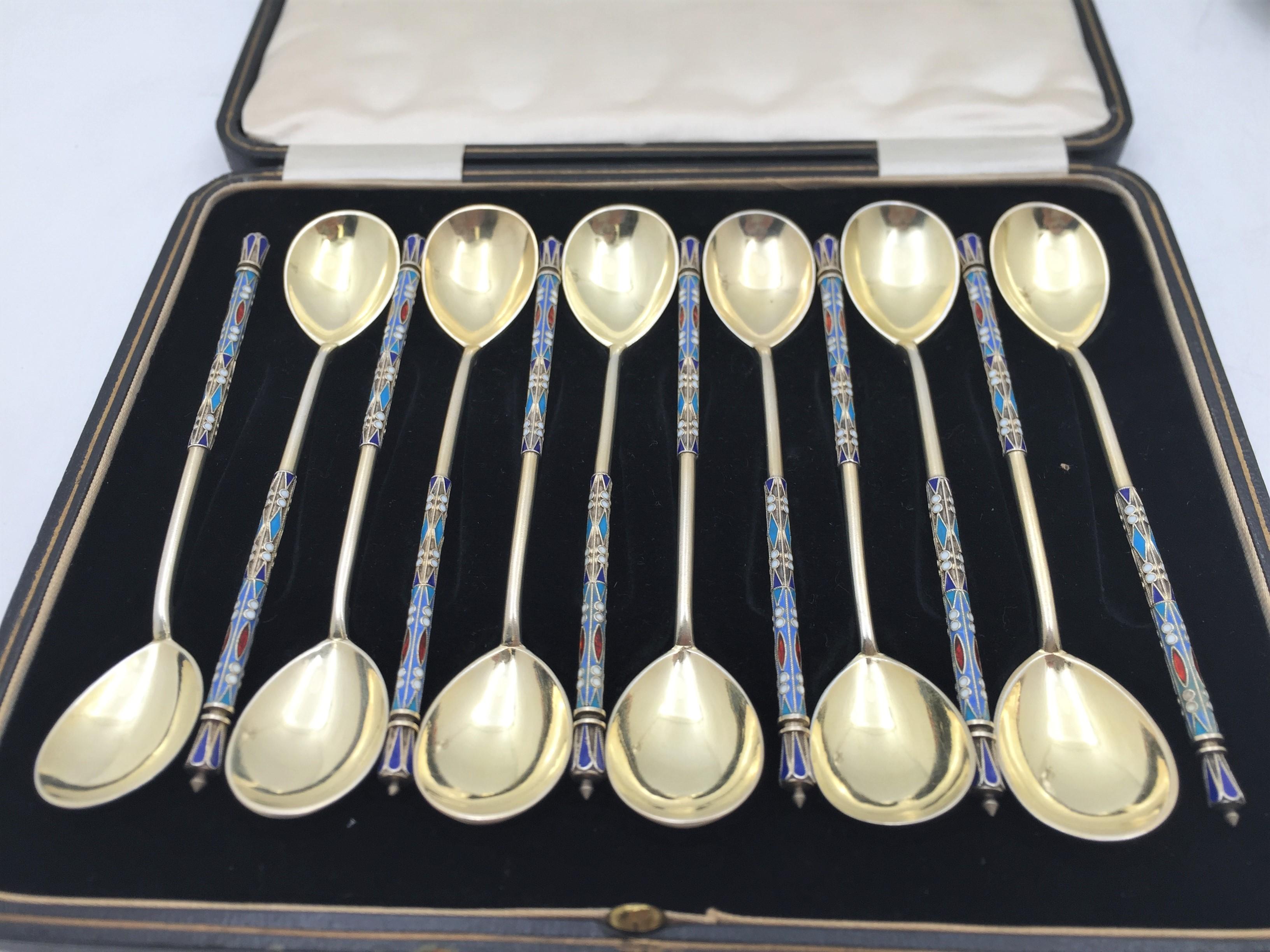 Ivan Saltykov, set of 12 Russian 0.910 gilt silver and enamel spoons in Faberge style from the late 19th or early 20th century, measuring 5 1/2'' in length by 1'' in width and bearing hallmarks as shown. This set is sold in the box which is shown.
