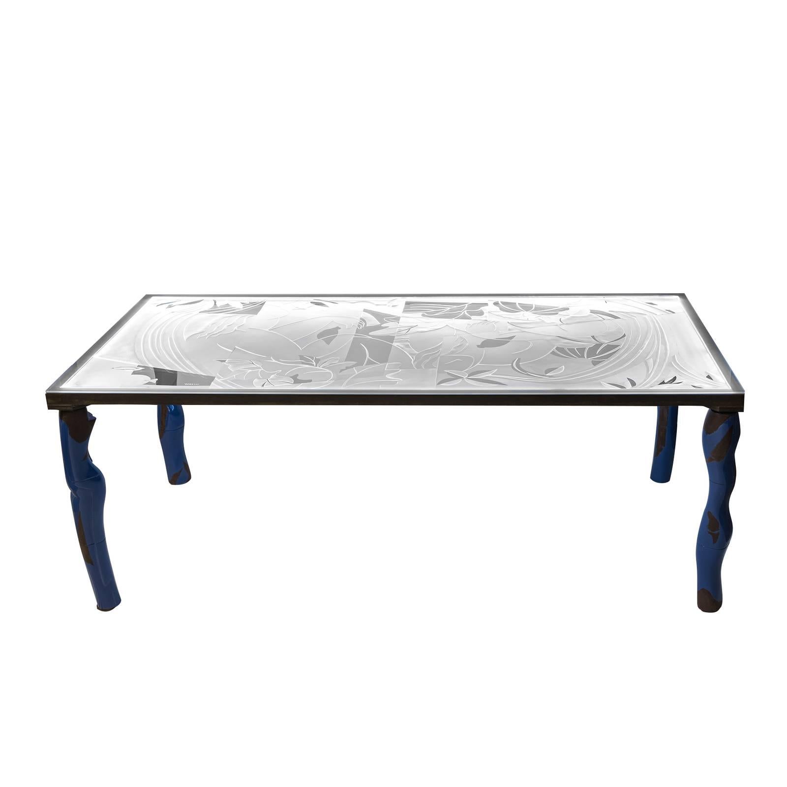 An impressive showcase of three-dimensional workmanship and innovative design, this avant-garde table is a sophisticated addition to any modern dining room. This piece boasts an ethereal frame with a rim in coated iron and sculptural legs in glazed