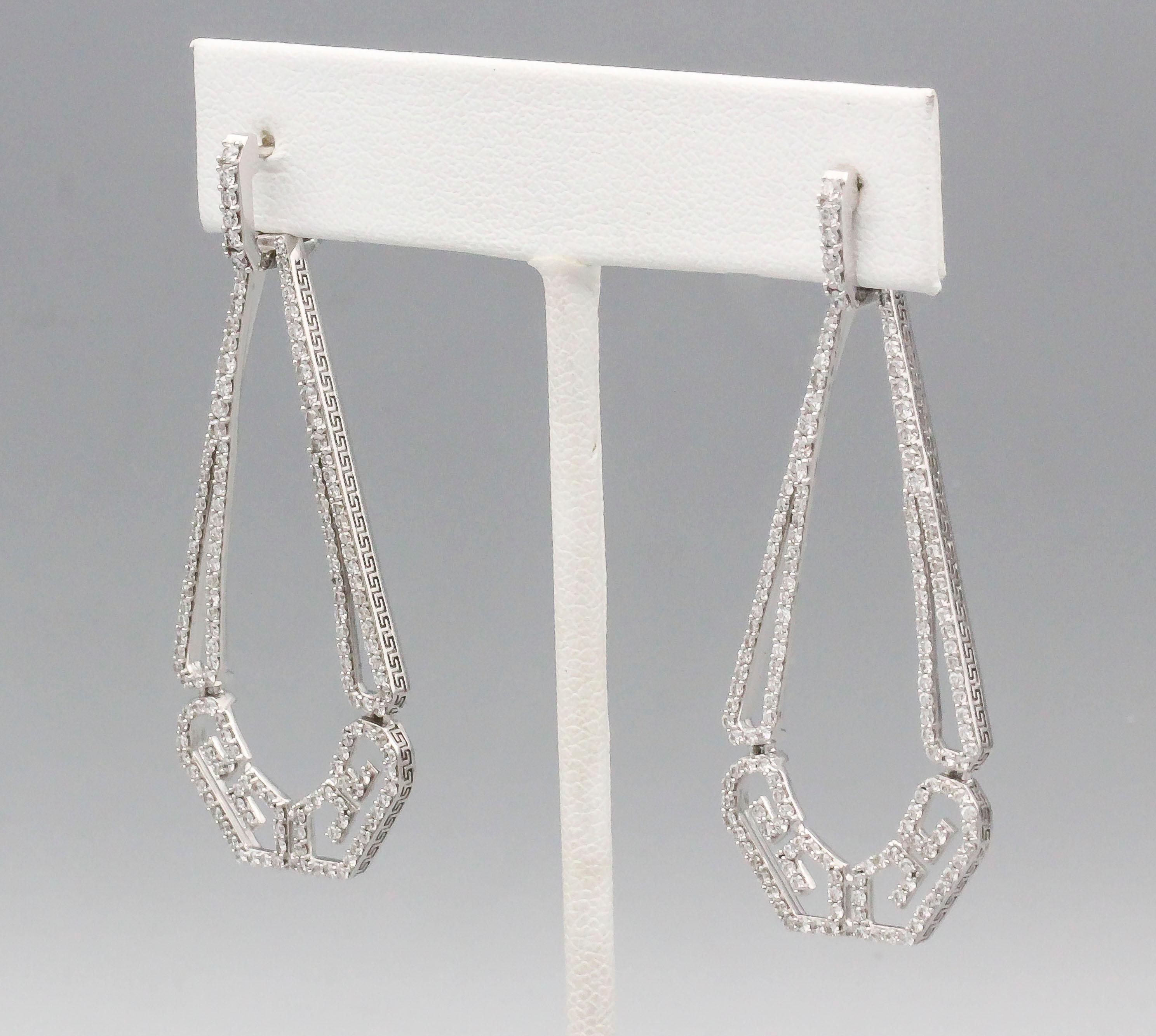 Fine diamond and 18K white gold drop earrings by Ivanka Trump. They feature high grade round cut diamonds throughout, approx. 1.5-2.0cts total weight.  The earrings are further decorated with a Greek key like pattern along its edges. Over 2 inches