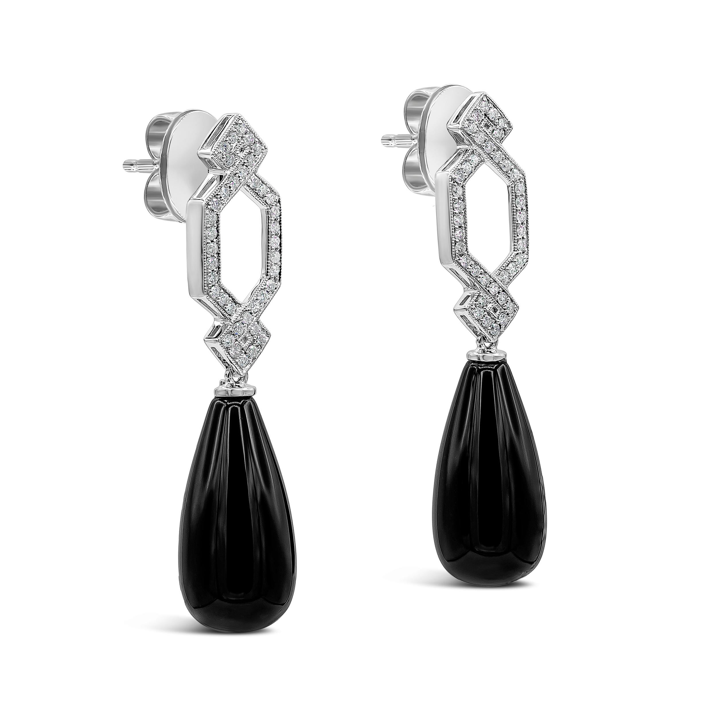 A stylish dangle earrings showcasing a pear shape drop onyx suspended in a diamond crossover made in 18 karat white gold. Diamonds weigh 0.28 carats total.

