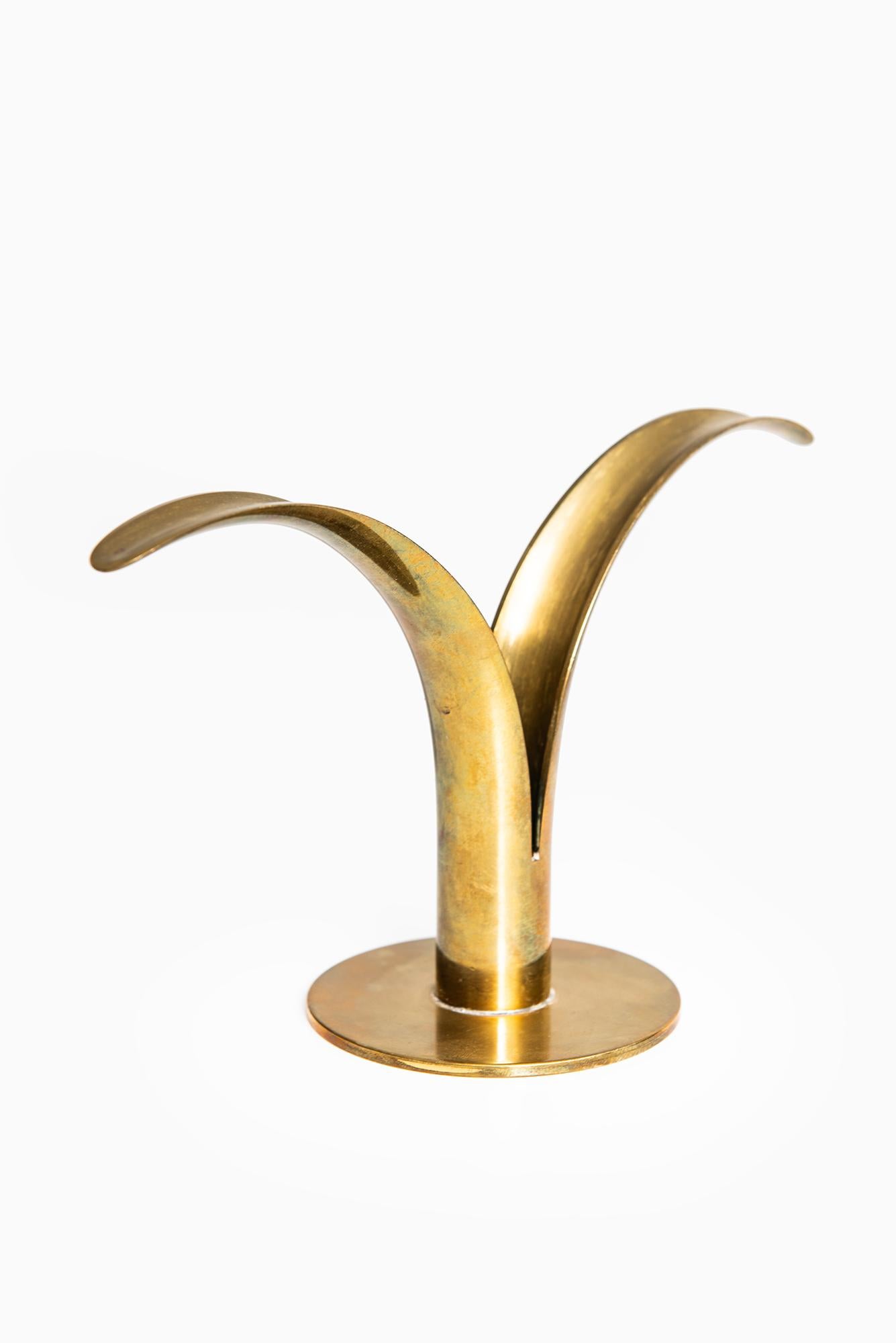 Set of 4 candlesticks model Lily / Liljan designed by Ivar Ålenius Björk. Produced by Ystad Metall in Sweden.