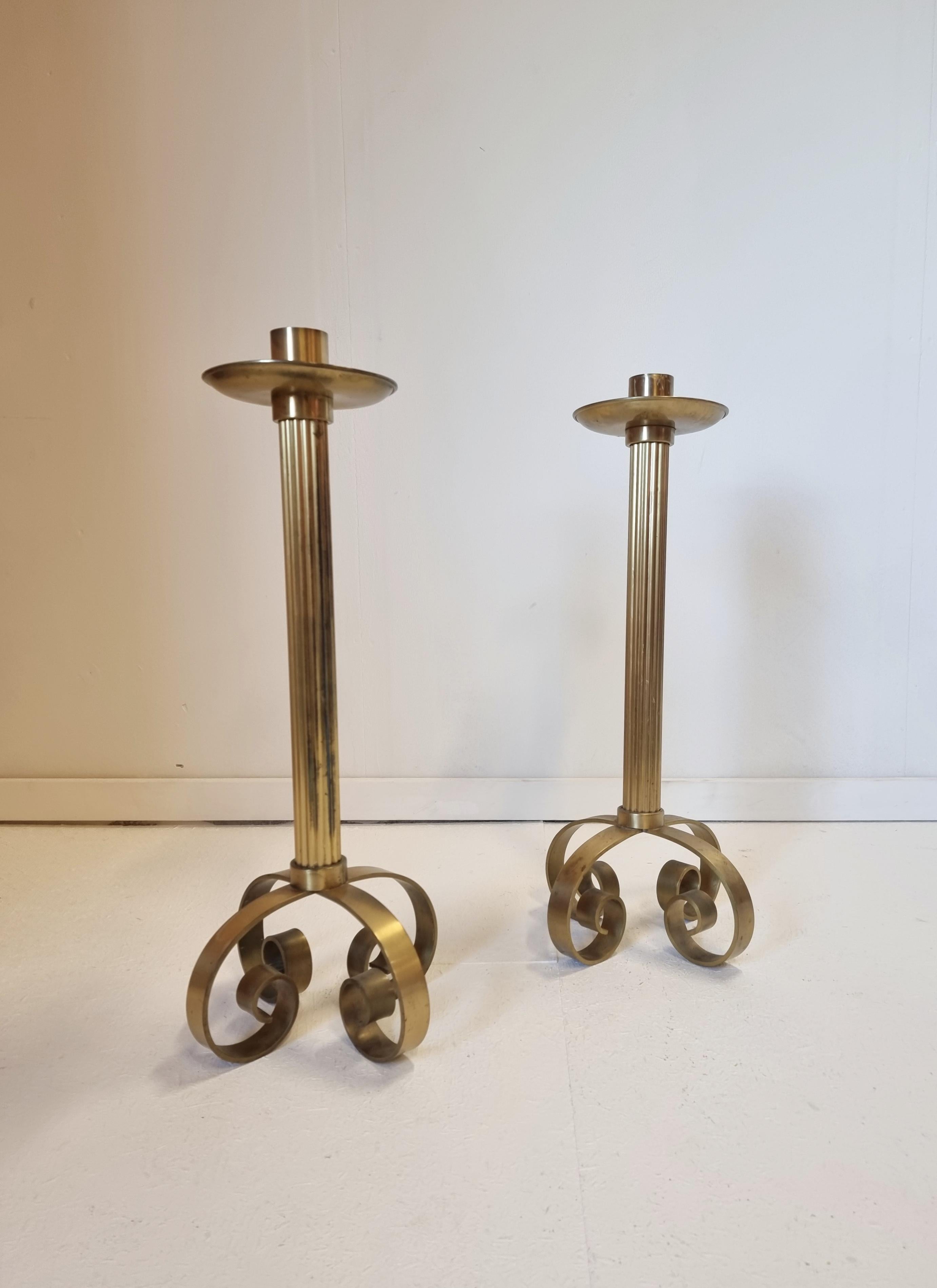 A pair of large candelabras in solid brass. Designed by Ivar Ålenius-Björk for Ystad Metall, Sweden, mid-1900s / Midcentury Modern. 

This pair is rare and with beautiful patina. Marked: YSTAD METALL SWEDEN IÅB

Smaller signs of age and wear.