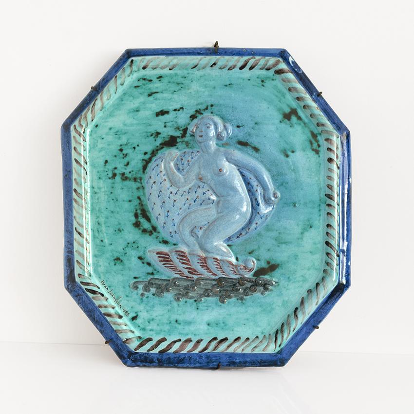 Ivar Johnsson (1885-1970): Wall relief depicting Venus on a half shell within an octagonal ceramic relief. The piece is signed and marked S: Erik Upsala, Ivar Johnson and dated 1920. 
W. 16.5 in; H. 19 in; D. 2 in.
