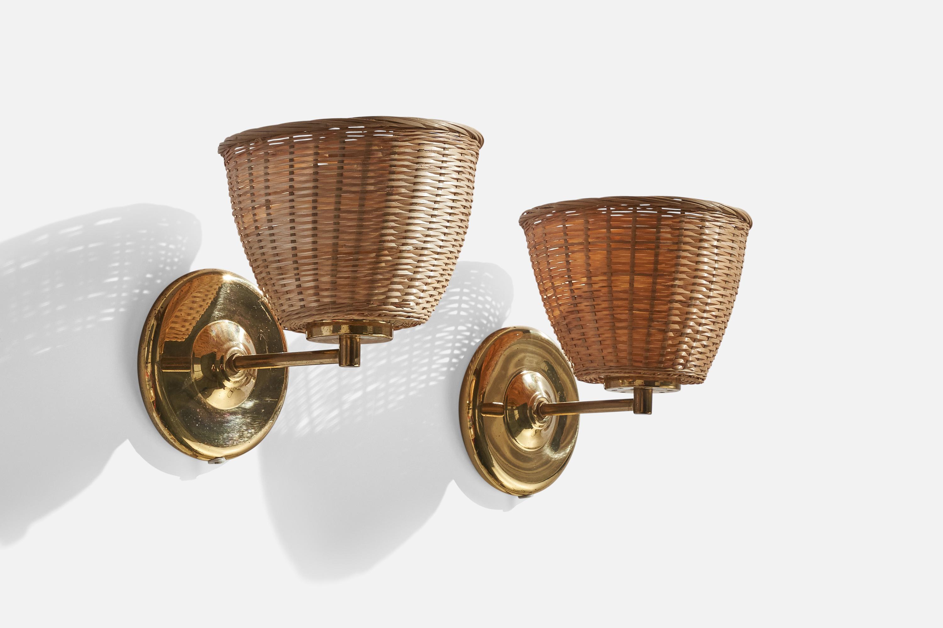 A pair of brass and rattan wall lights designed and produced by Ivars, Sweden, 1960s.

Overall Dimensions (inches): 8” H x 6.25” W x 8” D
Back Plate Dimensions (inches): 5” H x 5” W x .75” D
Bulb Specifications: E-26 Bulb
Number of Sockets: 2
All