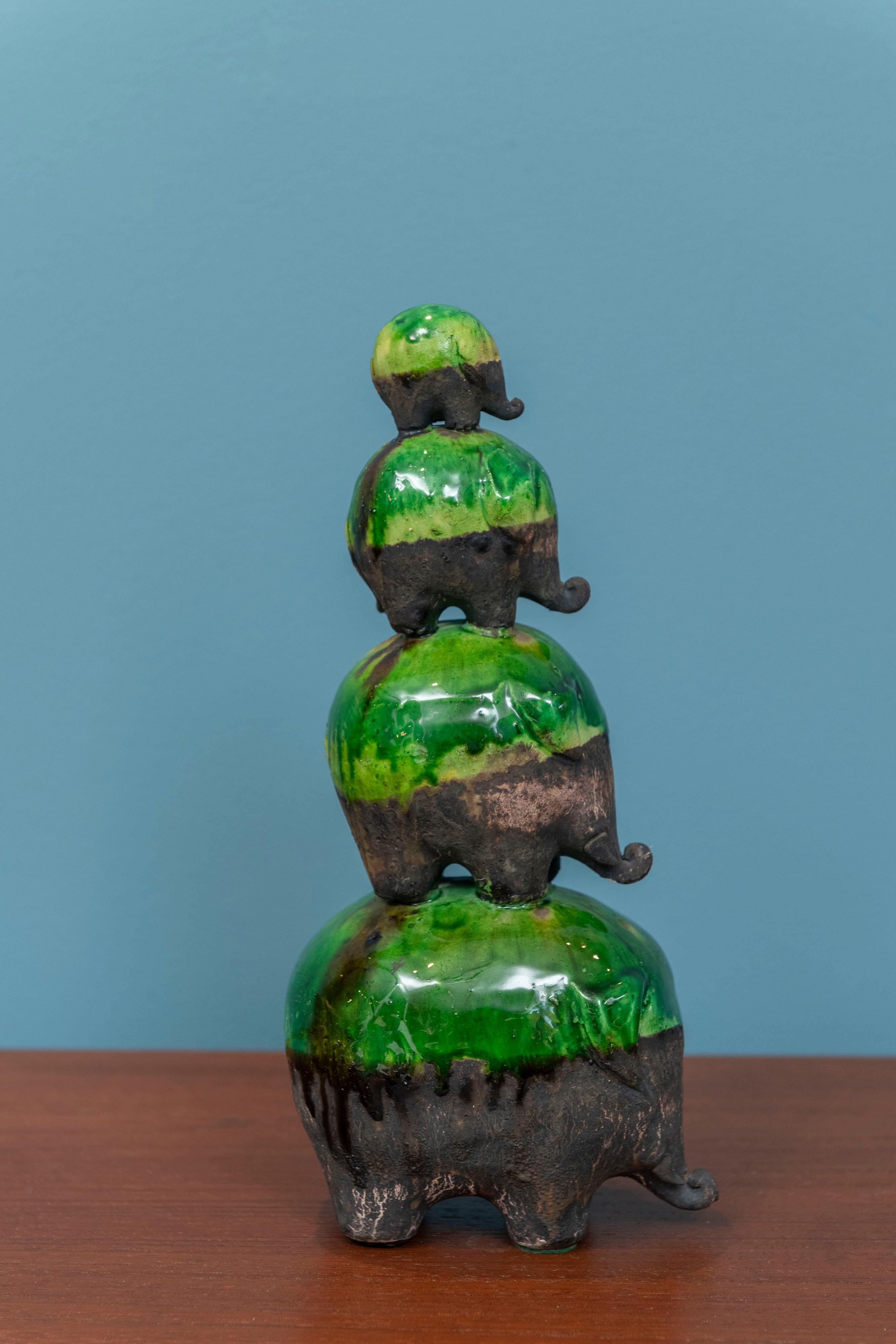 Ivo De Santis for Gil Etruschi, Italy. Polychromed ceramic family of elephants stacked on top of each other. Dad, Mom and two children playfully stacked in very good original condition. rare and collectible ceramic sculpture.