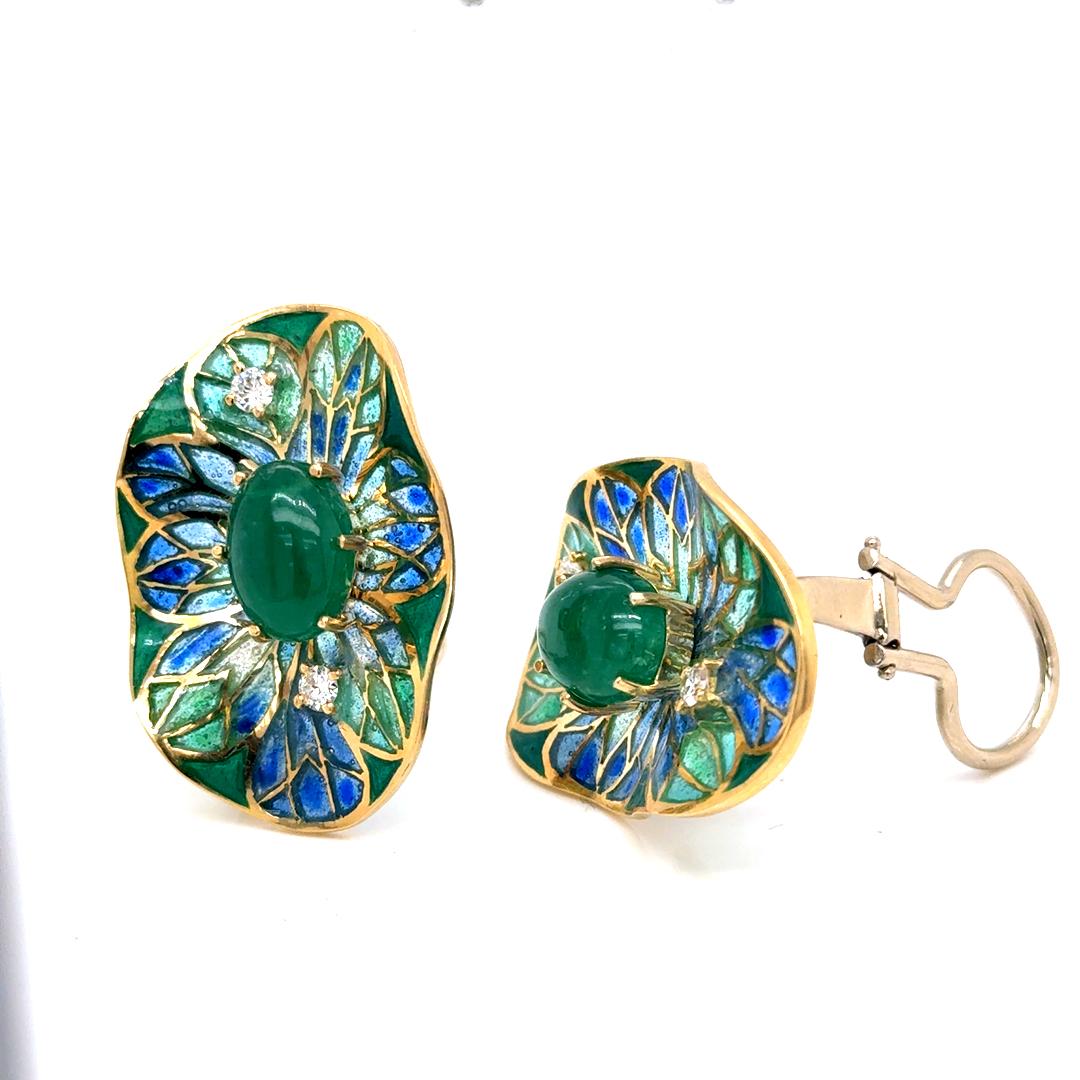 A rare and captivating vintage jewelry set by distinguished British jeweler Ivor Gordon, featuring an artistic fusion of hand-applied blue and green enamel, cabochon emeralds (9.20 cts aprox), and brilliant-cut diamonds (0.40 cts aprox), all set in