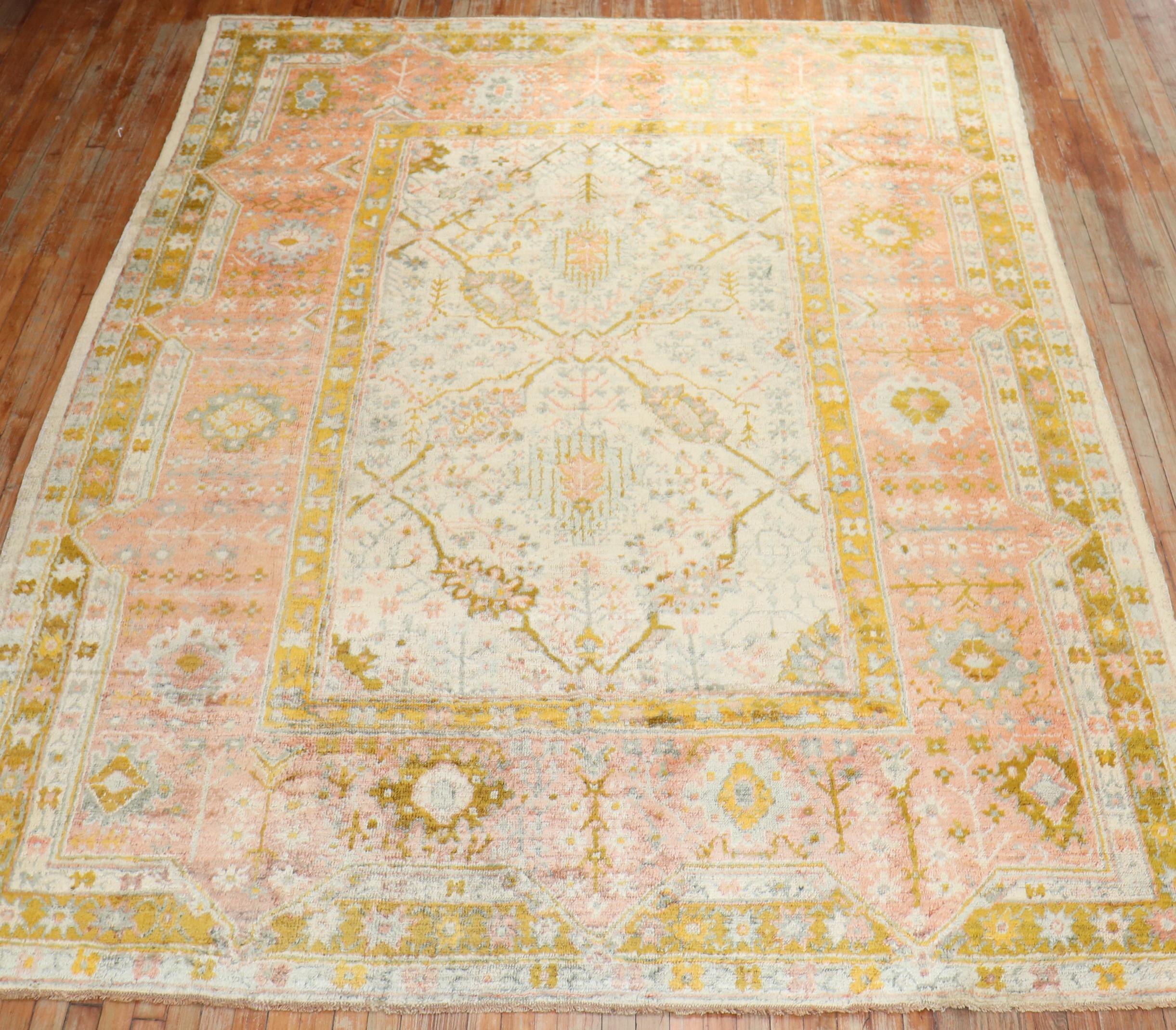 A circa 1900 authentic Angora Wool Overall Very Good Condition room size Turkish Oushak Rug with an all-over design with accent colors in goldenrod, pink and green on an ivory ground. The rug has a silky sheen to it

Measures: 8'5'' x