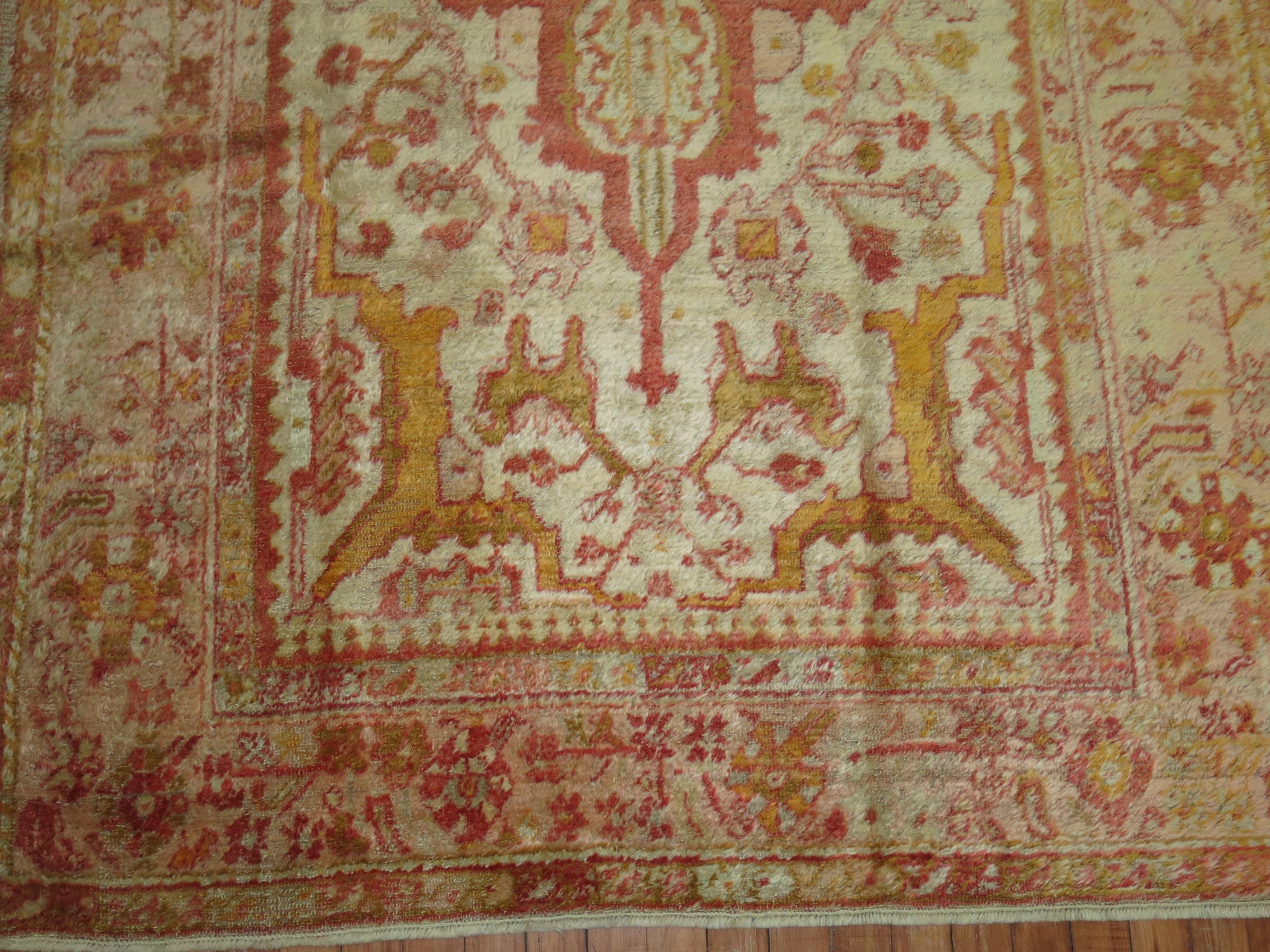 An early 20th century angora wool Oushak rug with a ivory colored field with other subtle warm accents. This is a genuine piece woven with angora goat wool and its an antique. There is no noticeable repairs or any condition issues at all.

4'8