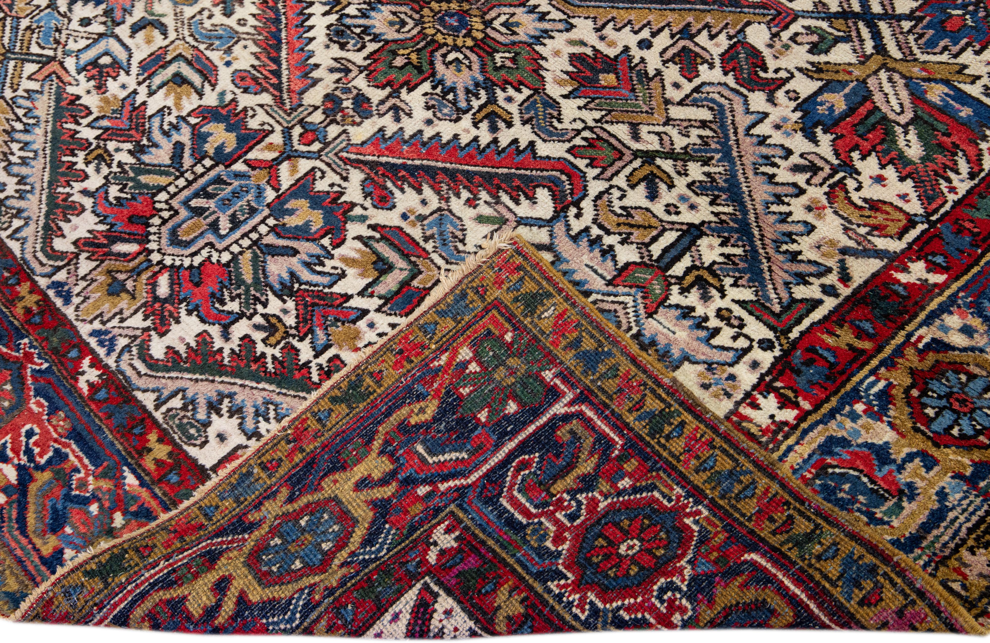 Schöner antiker, handgeknüpfter Heriz-Wollteppich mit marineblauem Feld. Dieser Heriz-Teppich hat einen rostigen Rahmen und mehrfarbige Akzente in einem herrlichen geometrischen Blumenmuster, das überall zu sehen ist.

Dieser Teppich misst: 6'8