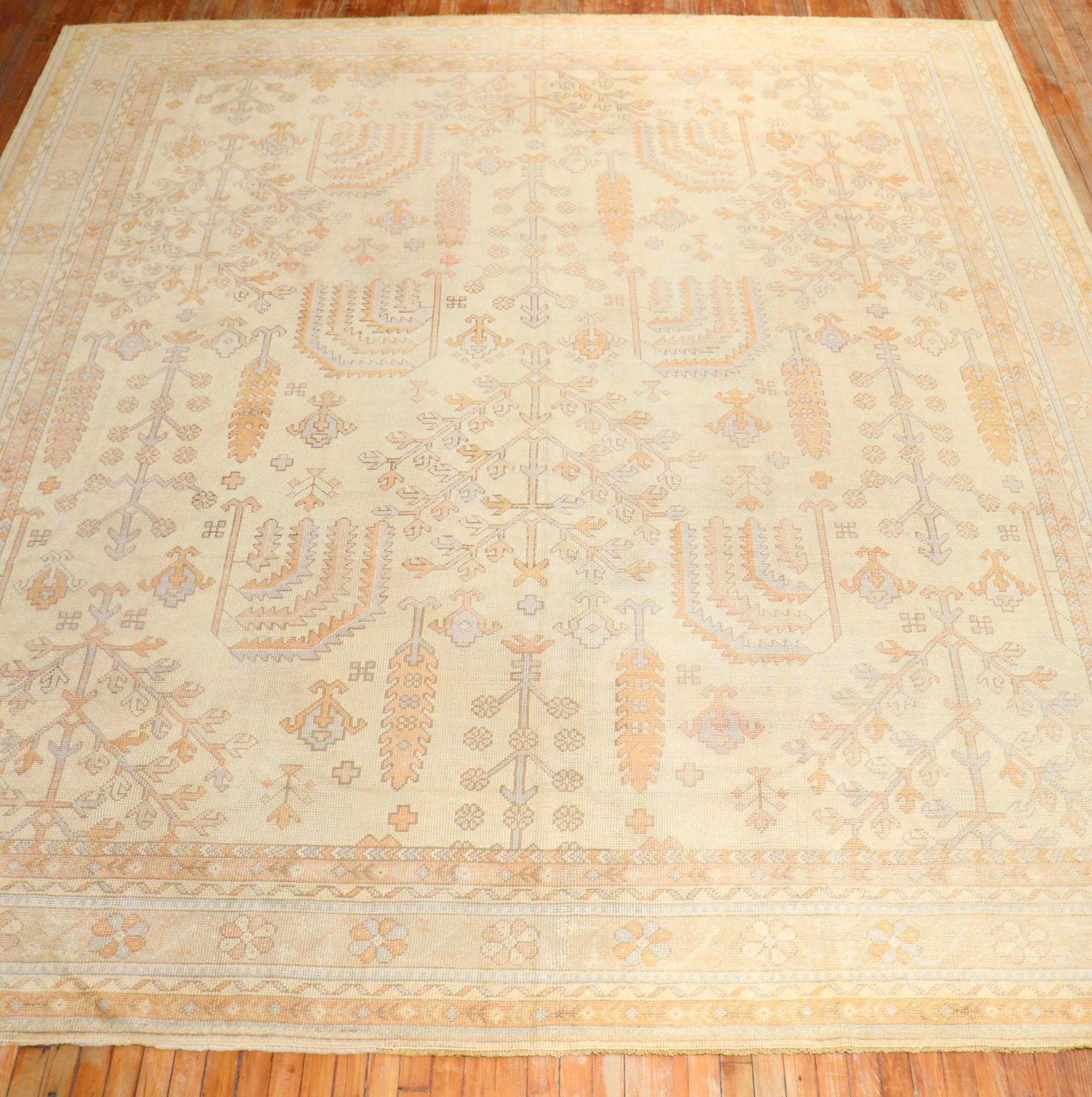 An early 20th-century square room size Turkish Oushak rug with a willow tree motif on an ivory ground

Measures: 11'1'' x 12'8