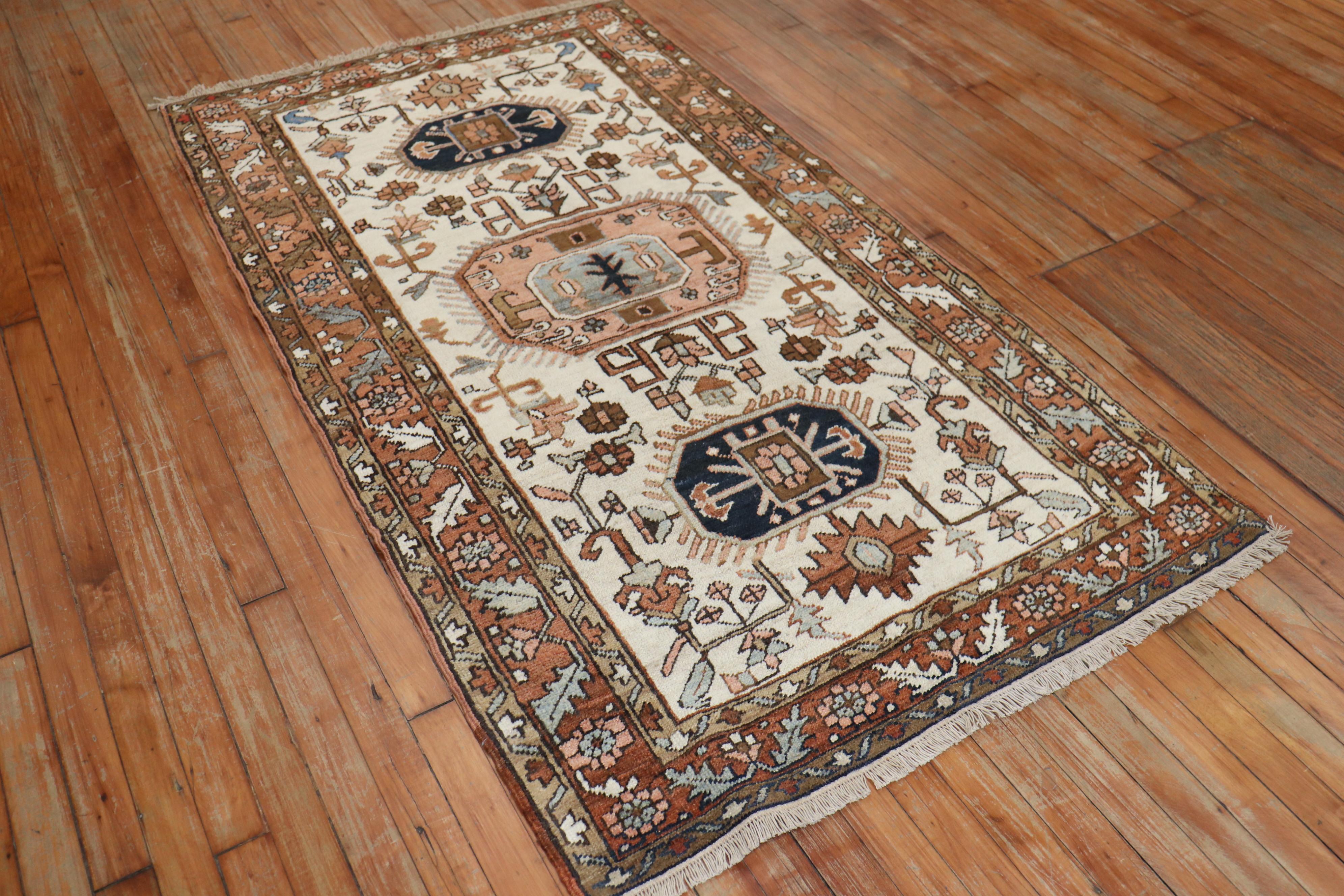 Persian Heriz tribal scatter rug consisting of an ivory field with dominant accents in brown

Measures: 3'3” x 5'11”.
