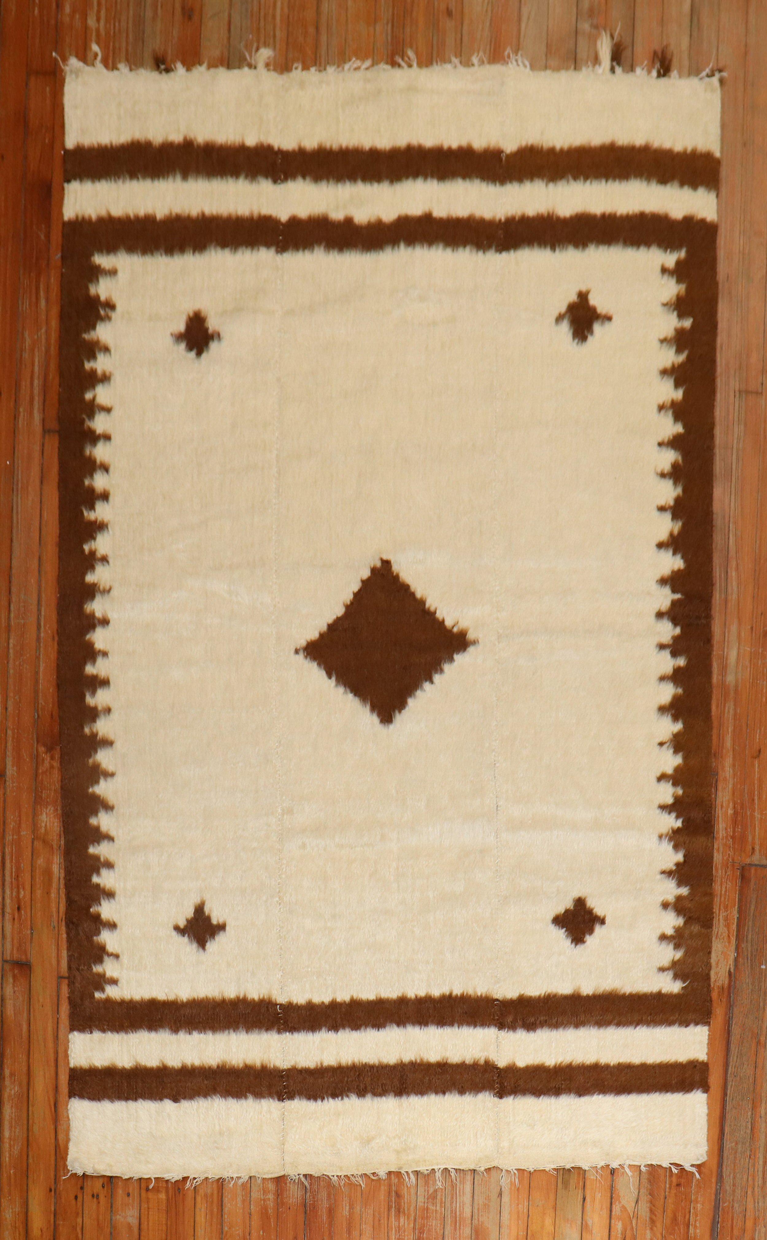 Vintage Angora mohair wool rug in brown and ivory.

Measures: 4'4'' x 6'9''.